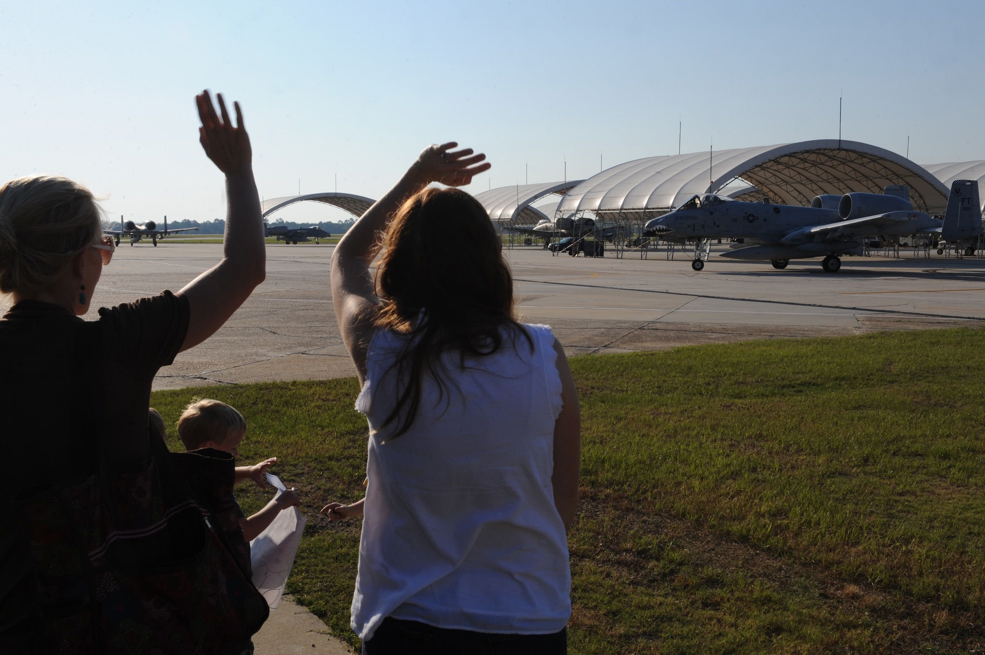 Families of Airmen assigned to the 75th Fighter Squadron wave goodbye to deploying Airmen at Moody Air Force Base, Ga., April 23, 2012.  While at Osan, 75th EFS pilots will fly a combination of close air support, airborne forward air controller and search and rescue training sorties. (U.S. Air Force photo by Staff Sgt. Ciara Wymbs/Released) 