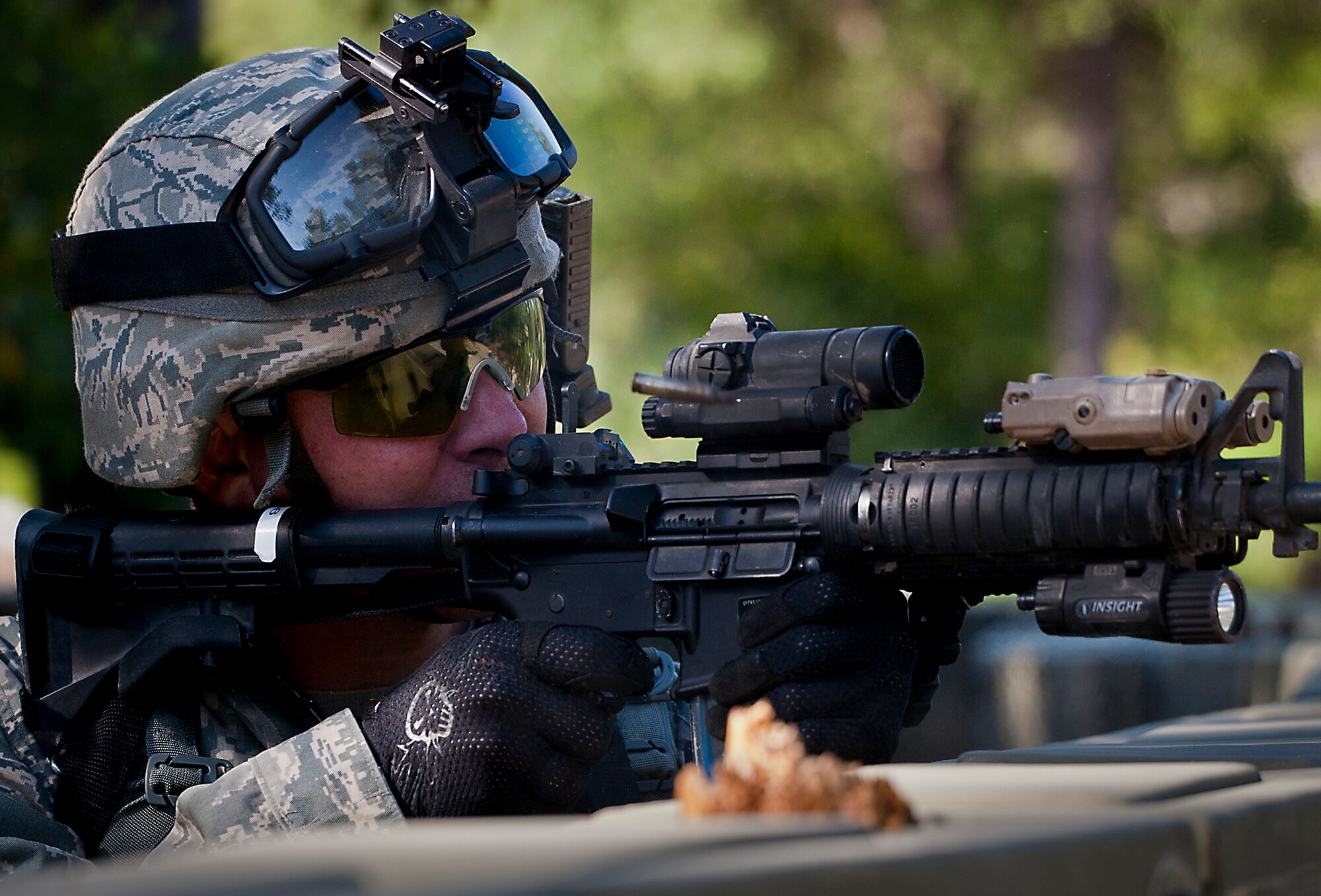 Staff Sgt. Justin Goad, of the 49th Security Forces Squadron, fires at the enemy trying to gain entry into his air base during the three-day Brave Defender field training exercise April 28 at Eglin Air Force Base, Fla.  The exercise is the culmination of Air Force Materiel Command’s six-week security forces deployment training, administered by the 96th Ground Combat Training Squadron. GCTS instructors teach 10 training classes a year, which consists of improvised explosive device detection and reaction, operating in an urban environment, mission planning, land navigation, casualty care and more. More than 100 active-duty and National Guard Airmen attended this training. (U.S. Air Force photo/Samuel King Jr.)
