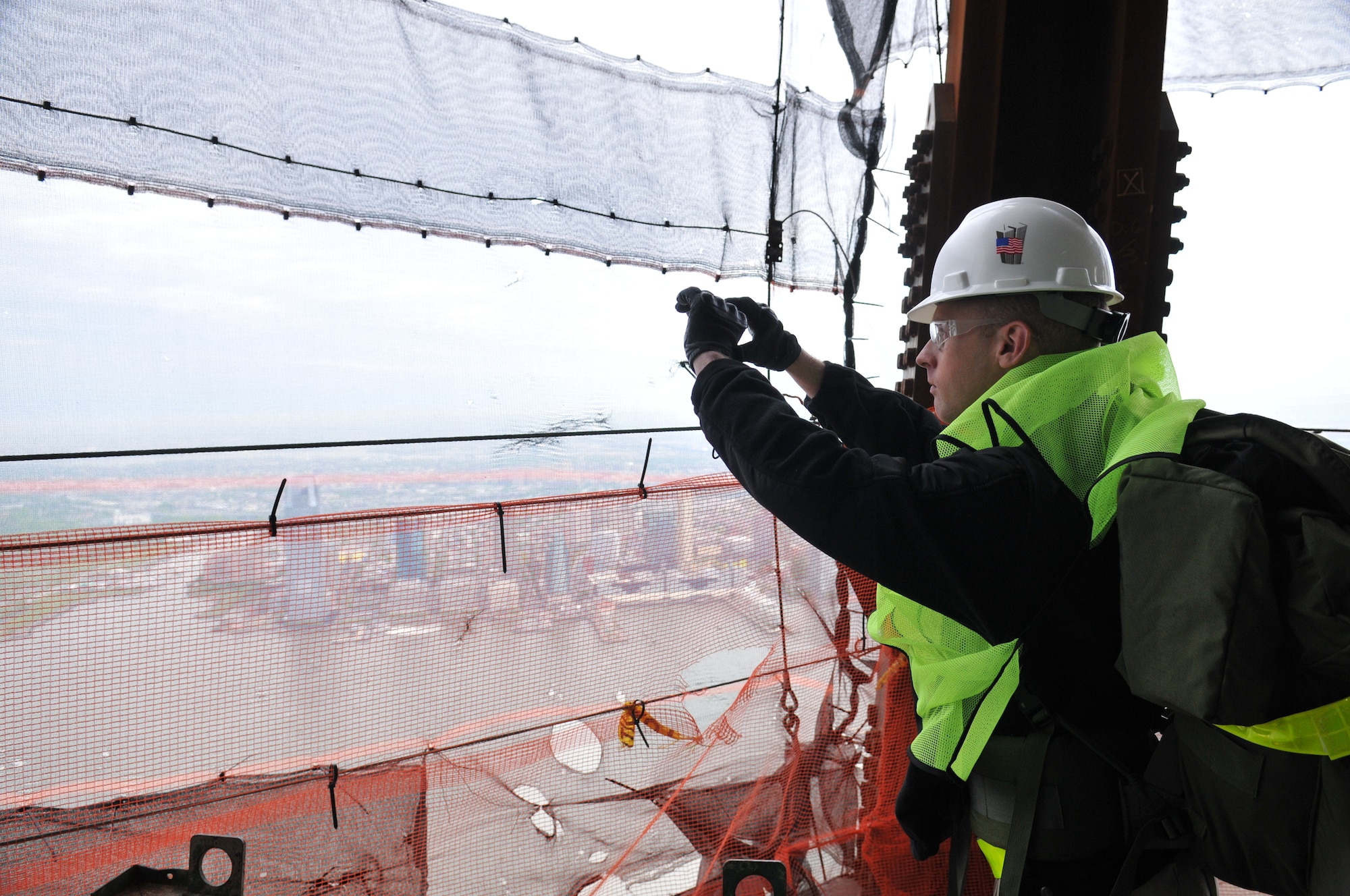 Lt. Col. J.D. Holt takes pictures from the 90th floor of the new One World Trade Center in New York City on April 26, 2012, before the Air Advisor Memorial Ruck March. The memorial march was an approximately 90-mile relay from the One World Trade Center to Joint Base McGuire-Dix-Lakhurst, N.J. Each ruck team member carried a paver stone with a name of one of the nine air advisors who were killed April 27, 2011, in Kabul, Afghanistan. (U.S. Air Force photo/Tech. Sgt. Brian E. Christiansen)