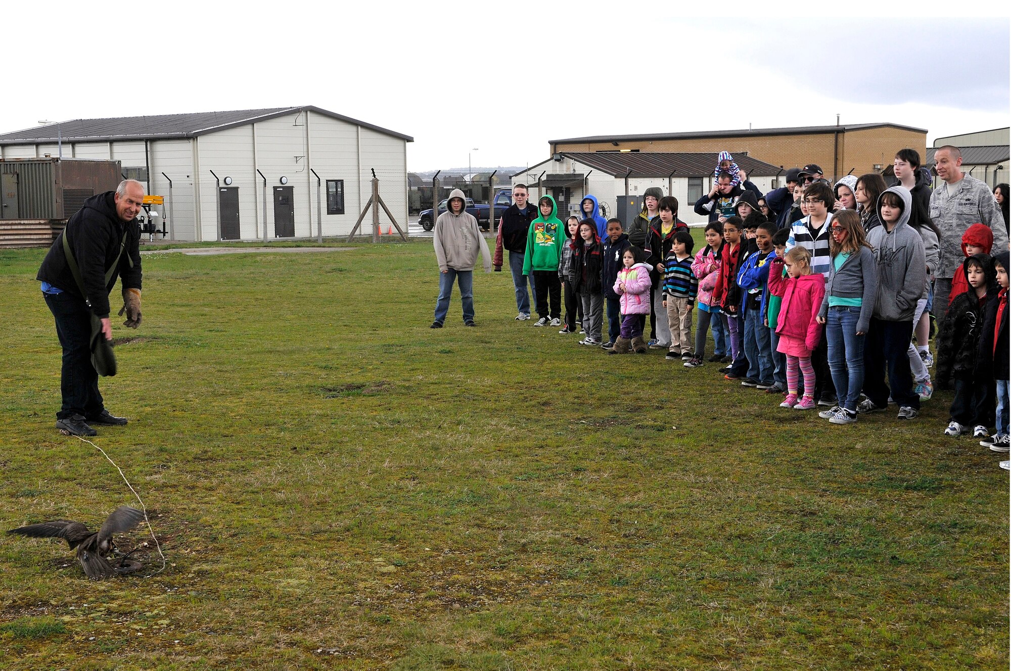 ROYAL AIR FORCE LAKENHEATH, England -- Feltwell and Lakenheath Elementary School students and parents watch Keith Mutton, Phoenix Bird Control handler, give a Birds of Prey demonstration as part of Job Shadow Day at RAF Lakenheath, England, April 27, 2012.  Job Shadow Day provided children the opportunity to see and learn about different Air Force jobs and allowed hands-on experience in an interactive environment. (U.S. Air Force photo by Staff Sgt. Connor Estes)