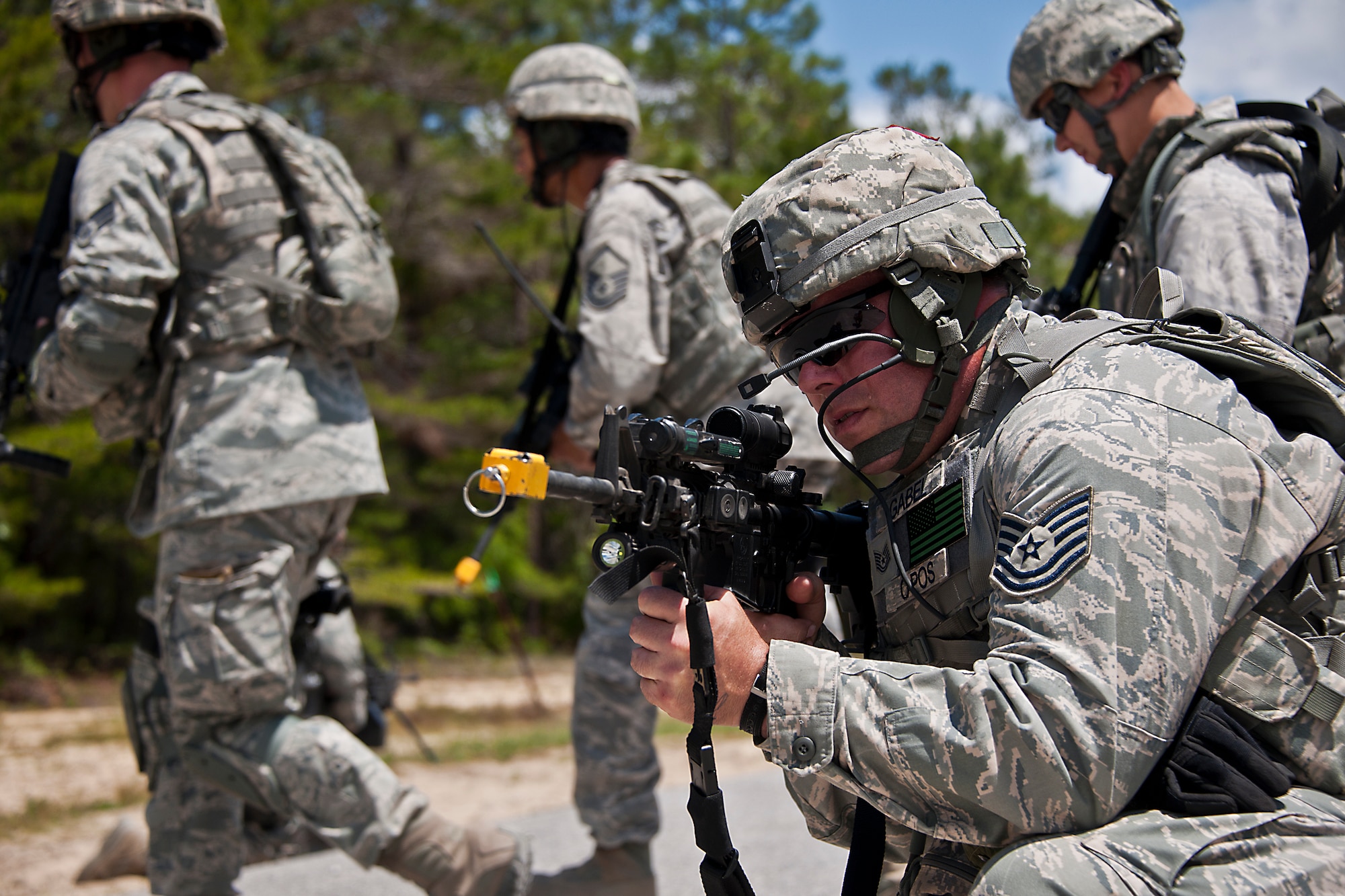 Tech. Sgt. Jeff Gabel, of the 137th Security Forces Squadron, covers his squad while practicing a ‘danger crossing’ procedure at the three-day Brave Defender field training exercise April 28 at Eglin Air Force Base, Fla.  The exercise is the culmination of Air Force Materiel Command’s six-week security forces deployment training, administered by the 96th Ground Combat Training Squadron. GCTS instructors teach 10 training classes a year, which consists of improvised explosive device detection and reaction, operating in an urban environment, mission planning, land navigation, casualty care and more. More than 100 active-duty and National Guard Airmen attended this training. (U.S. Air Force photo/Samuel King Jr.)