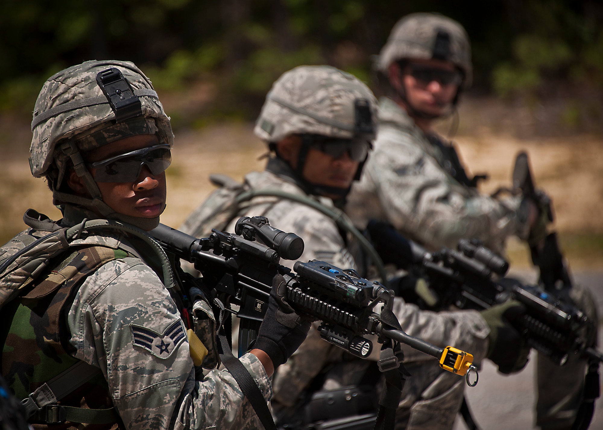 Security Forces Airmen check their six o’clock prior to a patrol during the three-day Brave Defender field training exercise April 28 at Eglin Air Force Base, Fla.  The exercise is the culmination of Air Force Materiel Command’s six-week security forces deployment training, administered by the 96th Ground Combat Training Squadron. GCTS instructors teach 10 training classes a year, which consists of improvised explosive device detection and reaction, operating in an urban environment, mission planning, land navigation, casualty care and more. More than 100 active-duty and National Guard Airmen attended this training. (U.S. Air Force photo/Samuel King Jr.)