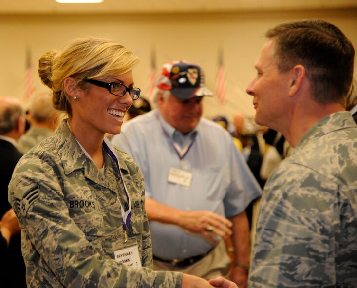 Senior Airman Bryenna Brooks, 2nd Medical Group, shakes the hand of Col. Thomas Hesterman, 2nd Bomb Wing vice commander, at the 2012 Prisoner of War/Purple Heart Luncheon on Barksdale Air Force Base, La., April 27. Brooks earned the Purple Heart last year when she was deployed to Afghanistan. (U.S. Air Force photo/Airman 1st Class Andrew Moua)(RELEASED)