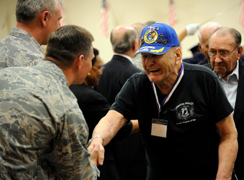 Lester Wilson, a retired Air Force veteran, shakes hands with Col. Thomas Hesterman, 2nd Bomb Wing vice commander, at the 2012 Prisoner of War/Purple Heart Luncheon on Barksdale Air Force Base, La., April 27. Veterans walked down the middle of Hoban Hall through a saber cordon to be honored for their service. (U.S. Air Force Photo/Airman 1st Class Andrew Moua)(RELEASED)