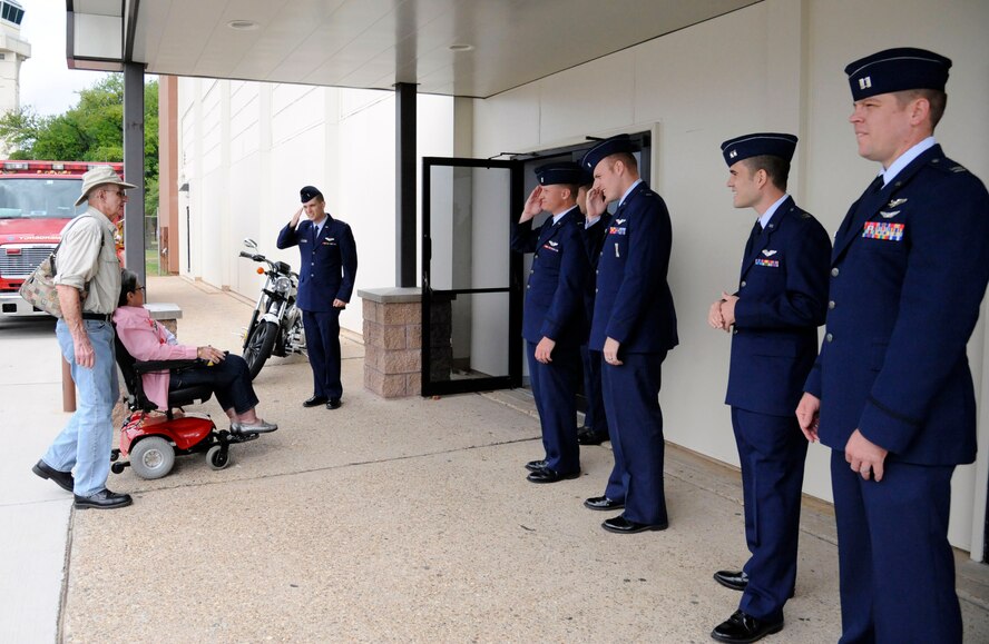 Air Force officers greet veterans outside Hoban Hall at the 2012 Prisoner of War/Purple Heart Luncheon on Barksdale Air Force Base, La., April 27. The officers stood outside as greeters to salute and honor those who have served before them. (U.S. Air Forcephoto/Airman 1st Class Andrew Moua)(RELEASED)