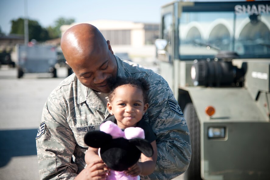 U.S. Air Force Staff Sgt Warren Shields, 23d Aircraft Maintenance Squadron crew chief, bonds with his daughter London before leaving for a deployment to Osan Air Base, Republic of Korea, April 22, 2012. Deployers had the chance to spend a couple hours with loved before boarding the bus. (U.S. Air Force Photo by Airman 1st Class Paul Francis/Released)
