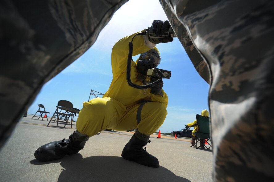Staff Sgt. Phillip Bailey, 39th Logistics Readiness Squadron receiving specialist, checks the exercise radiation levels on an Airman during a field training exercise April 27, 2012, at Incirlik Air Base, Turkey. The exercise tested emergency management's ability to respond effectively to an incident. (U.S. Air Force photo by Senior Airman Jarvie Z. Wallace/Released)
