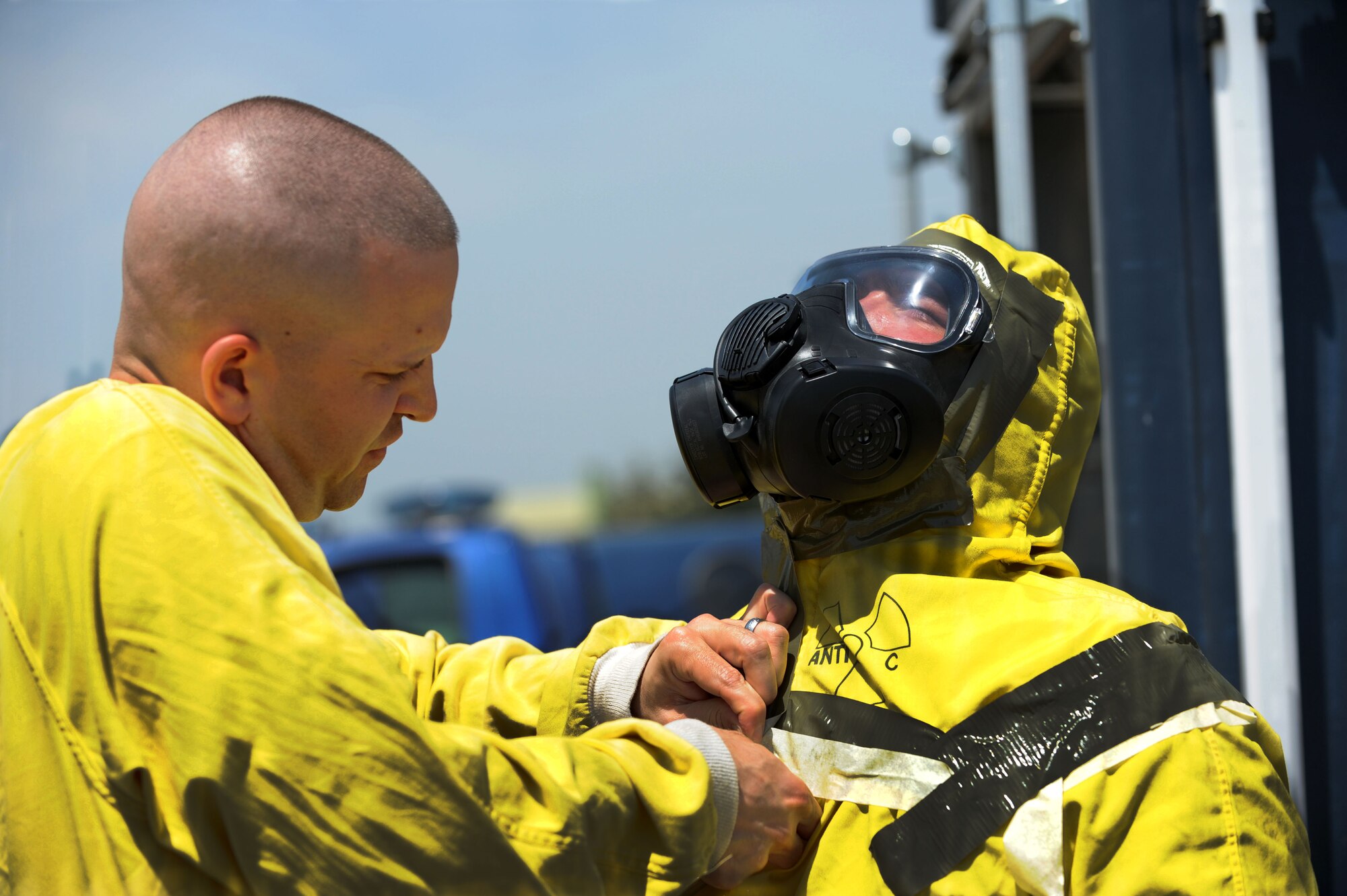 Tech. Sgt. Andrew Helms, 39th Logistics Readiness Squadron vehicle operations inspector, left, secures personal protective equipment on Staff Sgt. Brock Evans, 39th Civil Engineer Squadron emergency management technician during a field training exercise April 27, 2012, at Incirlik Air Base, Turkey. The exercise tested emergency management's ability to respond effectively to an incident. (U.S. Air Force photo by Senior Airman Jarvie Z. Wallace/Released)