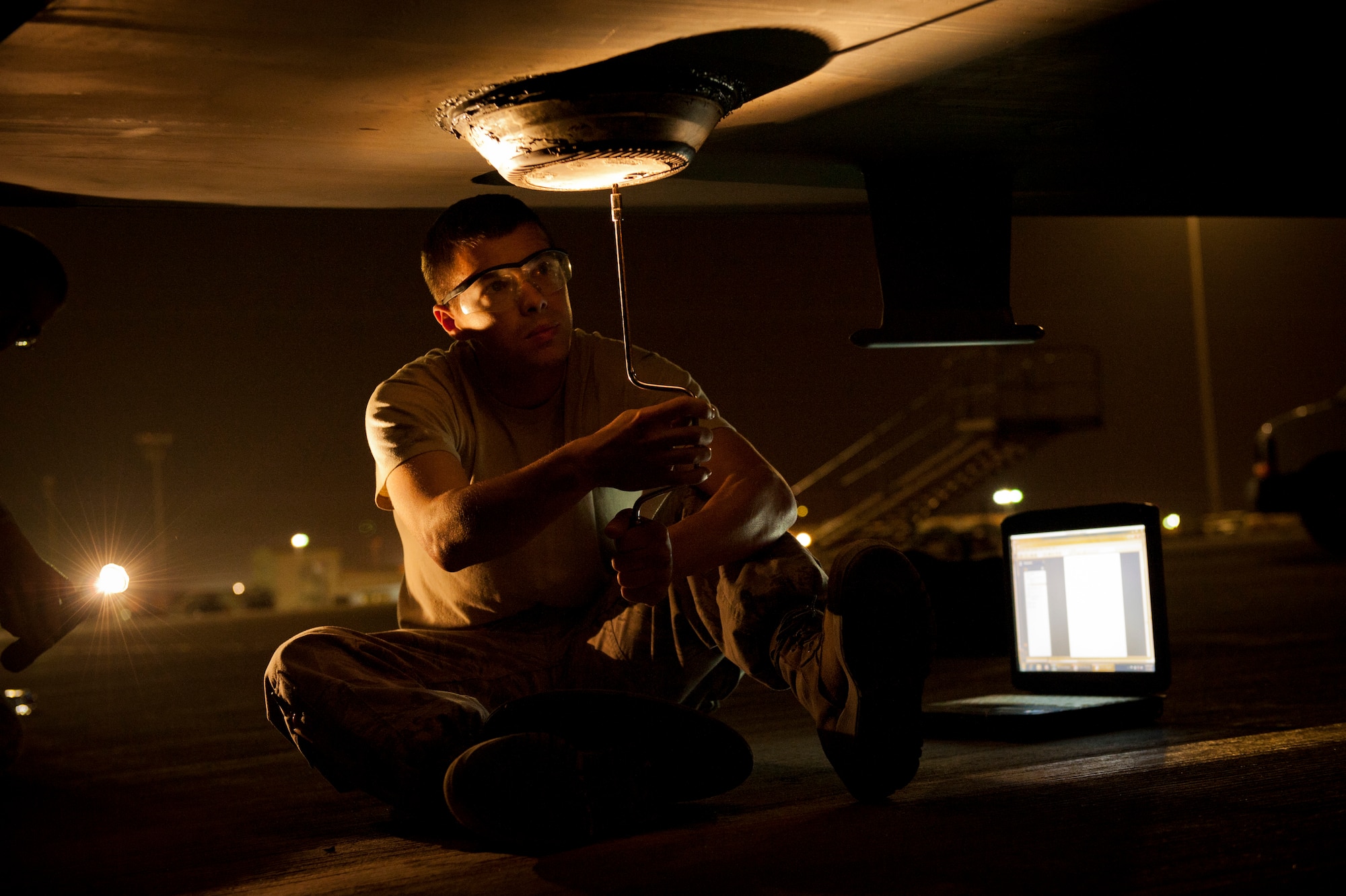 SOUTHWEST ASIA – Staff Sgt. Brandon Ferris, 8th Expeditionary Air Mobility Squadron dedicated crew chief, removes the anti-collision light on a C-17 Globemaster III here April 30. The light is removed for semi-prepped runway operations to prevent damage when the aircraft lands in adverse conditions or makeshift landing strips. (U.S. Air Force photo/Staff Sgt. Nathanael Callon)