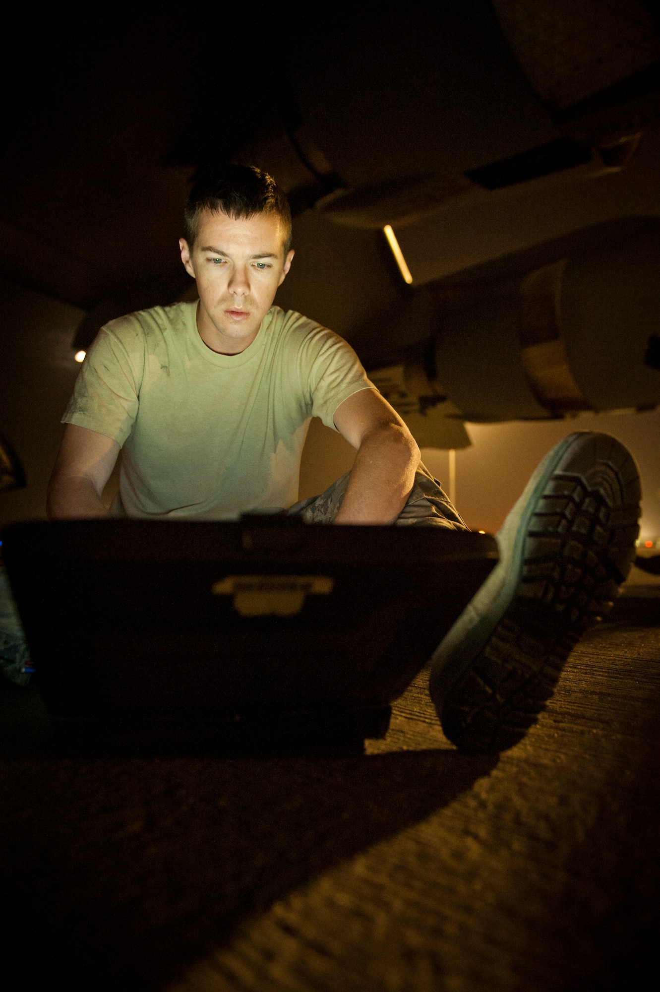 SOUTHWEST ASIA – Staff Sgt. Brandon Ferris, 8th Expeditionary Air Mobility Squadron dedicated crew chief, checks the technical order for removing an anti-collision light on a C-17 Globemaster III here April 30. The light is removed for semi-prepped runway operations to prevent damage when the aircraft lands in adverse conditions or makeshift landing strips. (U.S. Air Force photo/Staff Sgt. Nathanael Callon)