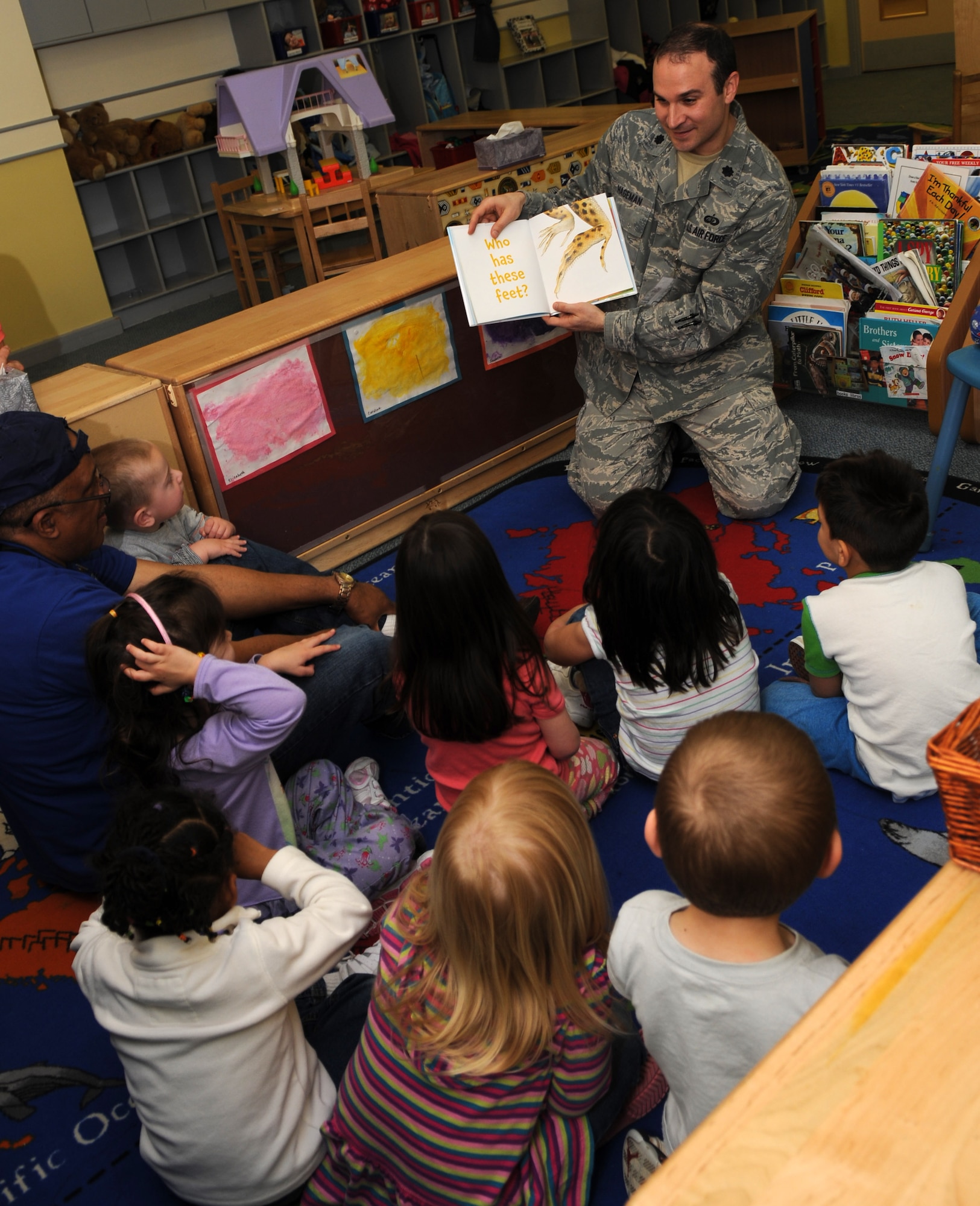 RAF MILDENHALL, England – Lt. Col. Adrian Hageman, 100th Force Support Squadron commander, reads to 3-to-5-year old children at the RAF Mildenhall Child Development Center April 27, 2012, in honor of the Month of the Military Child. The Month of the Military Child honors approximately 1.2 million military children, under the age of 18, for all the sacrifices made in support of their parents’ military service. (U.S. Air Force photo/Senior Airman Rachel Waller)