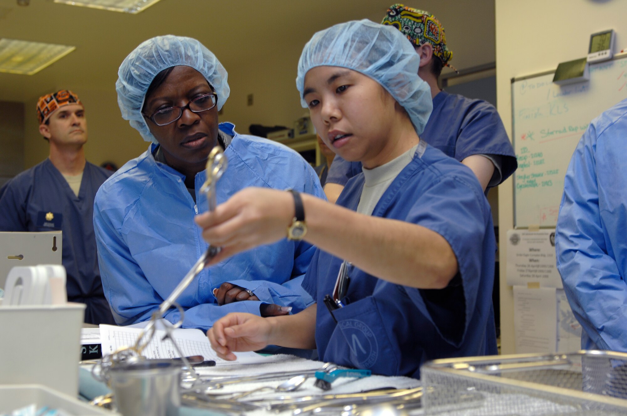 ROYAL AIR FORCE LAKENHEATH, England -- Airman Basic Yu Tun, 48th Medical Surgical Operations Squadron surgical technician, shows Chief Master Sgt. SaRita Lathan, 48th Fighter Wing command chief, how she prepares instruments prior to procedures April 25, 2012. The tour was part of an initiative by the 48th Medical Group to give the wing’s new commander insight into their operations. (U.S. Air Force photo by Tech. Sgt. Lee A. Osberry Jr.)