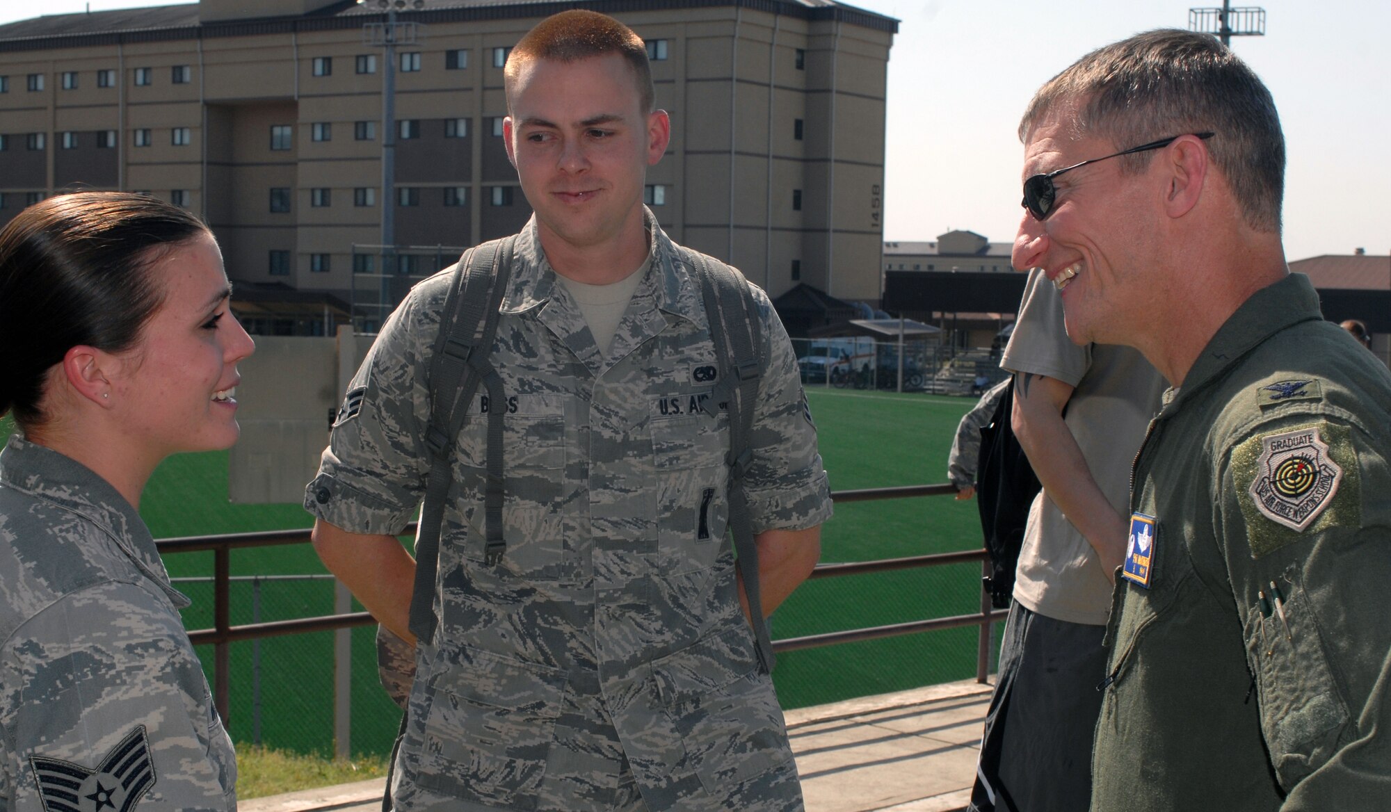 Col. Patrick McKenzie, 51st Fighter Wing commander, relishes passing the Consolidated Unit Inspection grade April 30, 2012, with Staff Sgt. Kalyn Mills and Senior Airman Nathan Bass, both assigned to the 51st Munitions Squadron.  After announcing the CUI grades, everyone was invited to a party to celebrate.  (U.S. Air Force photo / Senior Master Sgt. Stuart Camp)