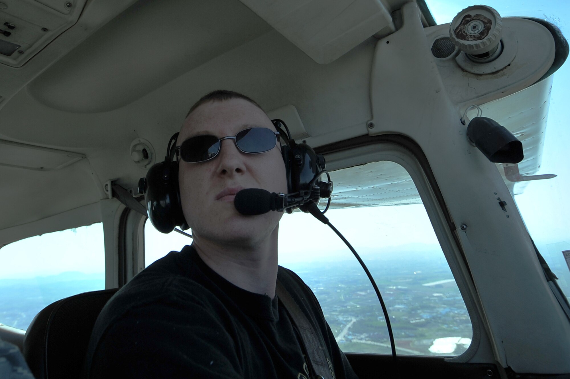 Senior Airman Joseph Cider, 51st Maintenance Squadron aircraft structural maintainer, flies a Cessna 172 in a traffic pattern at 1,200 feet, Osan Air Base, Republic of Korea, April 30, 2012. Cider is a member of the 51st Force Support Squadron Aero Club. (U.S. Air Force photo/Staff Sgt. Craig Cisek)