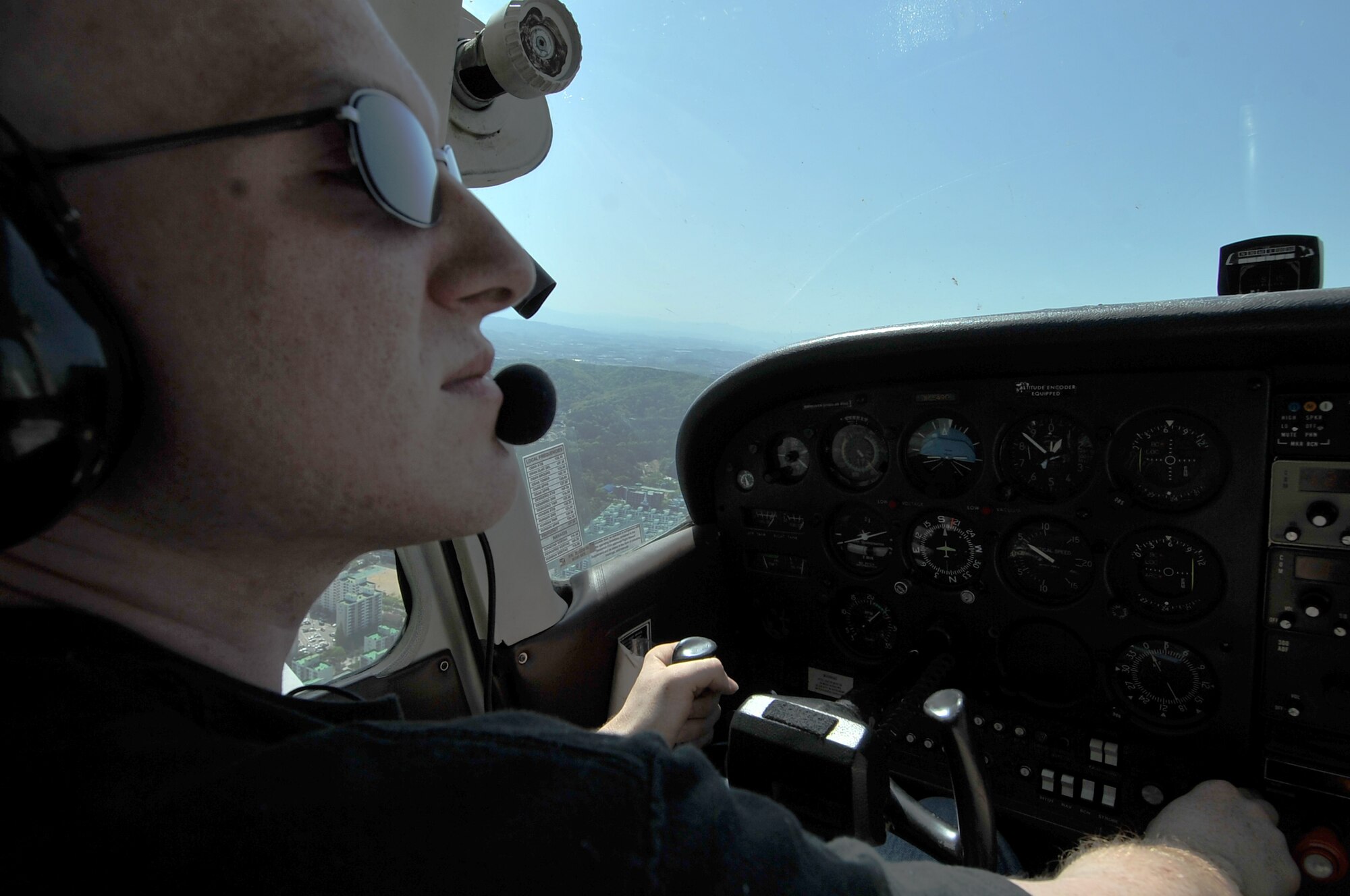 Senior Airman Joseph Cider, 51st Maintenance Squadron aircraft structural maintainer, flies a Cessna 172 in a traffic pattern at 1,200 feet, Osan Air Base, Republic of Korea, April 30, 2012. Cider is a member of the 51st Force Support Squadron Aero Club. (U.S. Air Force photo/Staff Sgt. Craig Cisek)