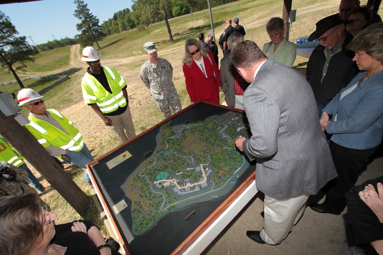 FORT A.P. HILL, Va. — A group of local residents, U.S. Army Corps of Engineers Norfolk District employees and Fort A.P. Hill employees look over a model of the new Asymmetric Warfare Group's battle laboratory complex here, April 25, 2012. The $62 million complex, construction of which was overseen by the U.S. Army Corps of Engineers Norfolk District, will provide the Army with an area to test and adapt operating procedures to ever-changing wartime scenarios. 