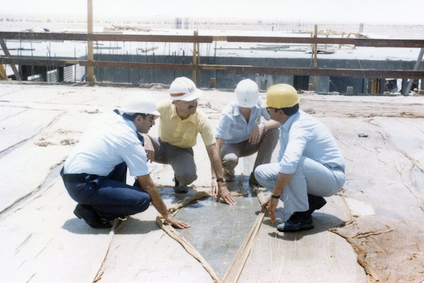 Kuwait Air Force Capt. Youseph Mandani, Ceasar Santucci, U.S. Army Corps of Engineers Chief Quality Control Kaleel al Rai and Project Manager Jaffer Karimi inspect the newly placed concrete roof of the Flight Training Center in Kuwait, fall 1985.