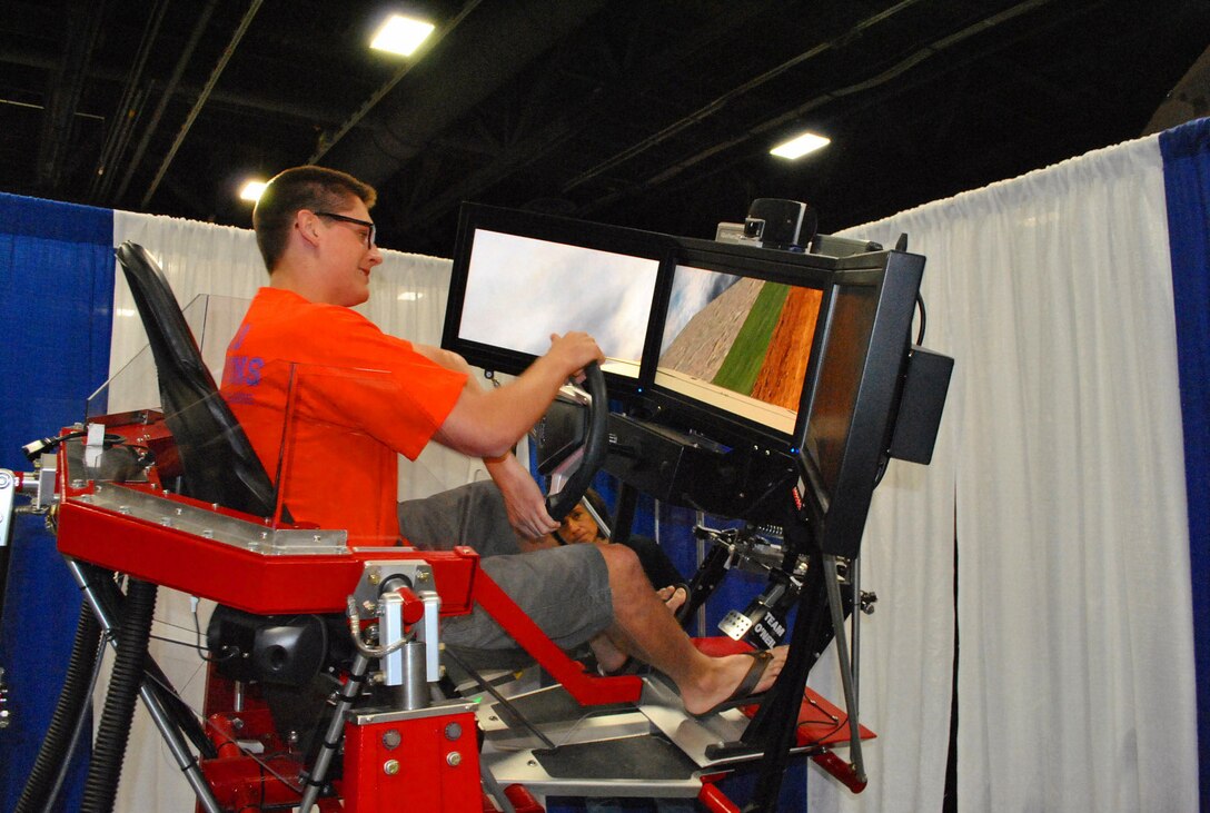 WASHINGTON, D.C. — Duncan Kay of Arlington, Va. maneuvers over ice, gravel, sand, rock and even negotiates around a roadside bomb on the Synthetic Automotive Virtual Environment, or SAVE, April 29 at the 2012 USA Science and Engineering Expo. SAVE was developed by researchers at the U.S. Army Corps of Engineers' Cold Regions Research and Engineering Laboratory.