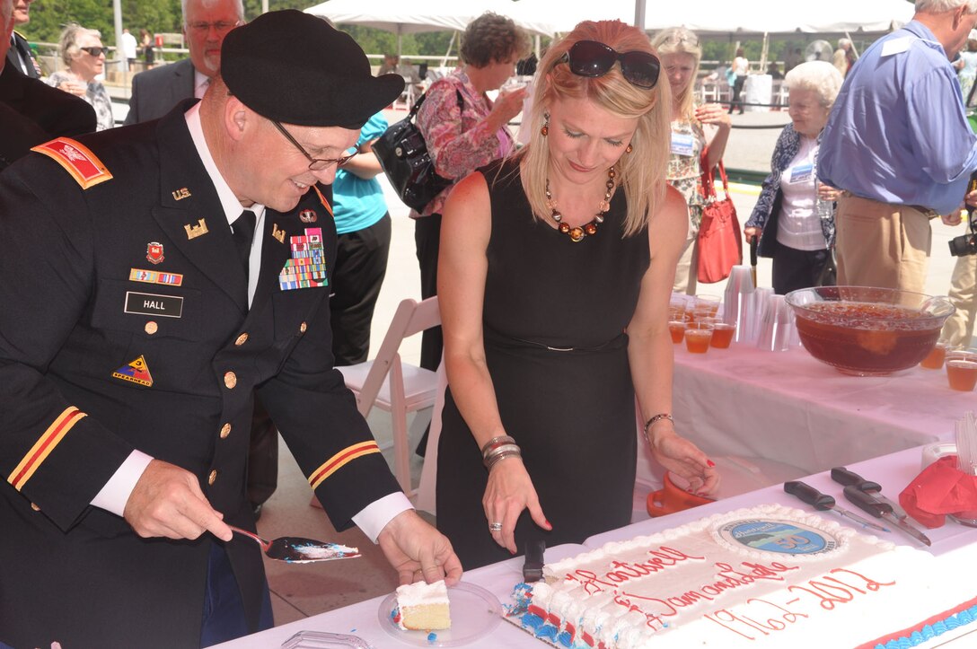 HARTWELL, Ga. — Col. Jeff Hall, Commander of the U.S. Army Corps of Engineers Savannah District, cuts a piece of cake at the 50th Anniversary Ceremony of the Hartwell Dam and Lake, April 27, 2012. Pictured with Hall is Angel Morrill of the Hartwell Project Office.