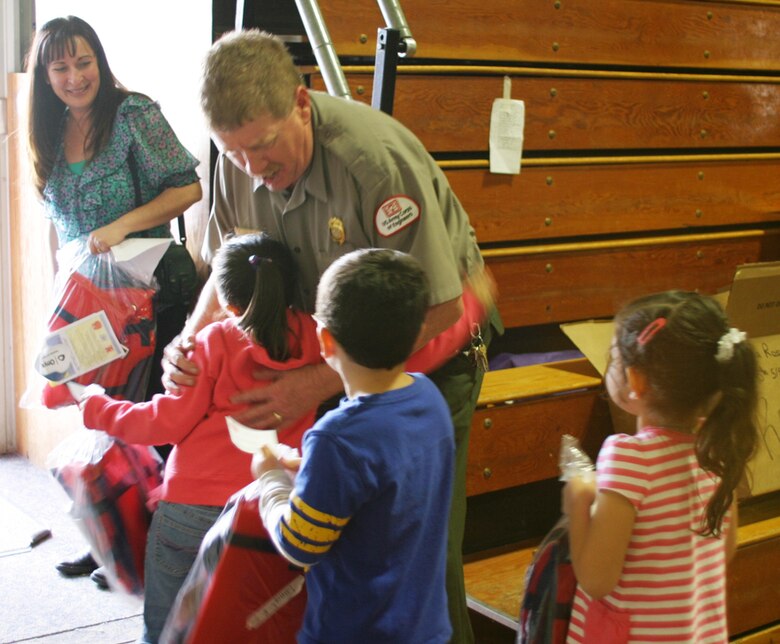 Park Ranger Robert Mumford helps distribute lifejackets to Santa Rosa Elementary School Students.  He reminds them to always wear a vest when on the water. 