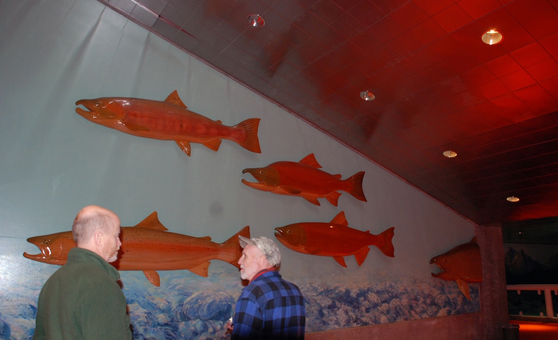 Lee Jensen and Pat Barry review the many paintings Lee had done, such as this mural of fish adorning a hallway. Bonneville Lock and Dam is known for many things, like history and hydropower, but artwork? Lee Jensen, who worked there between 1991 and 2001, left his mark ... in a very creative way.