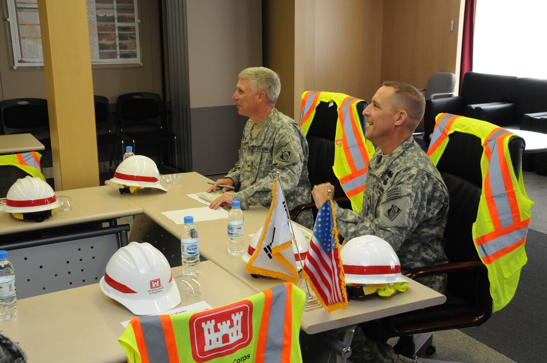 Brig. Gen. Richard Stevens, U.S. Army Corps of Engineers, Pacific Ocean Division Commander, and Col. Donald E. Degidio, Jr., Commander of the Far East District, listen to a briefing on Korea Transformation construction presented by Greg Reiff, Humphreys Area Office Resident Engineer, April 3.  