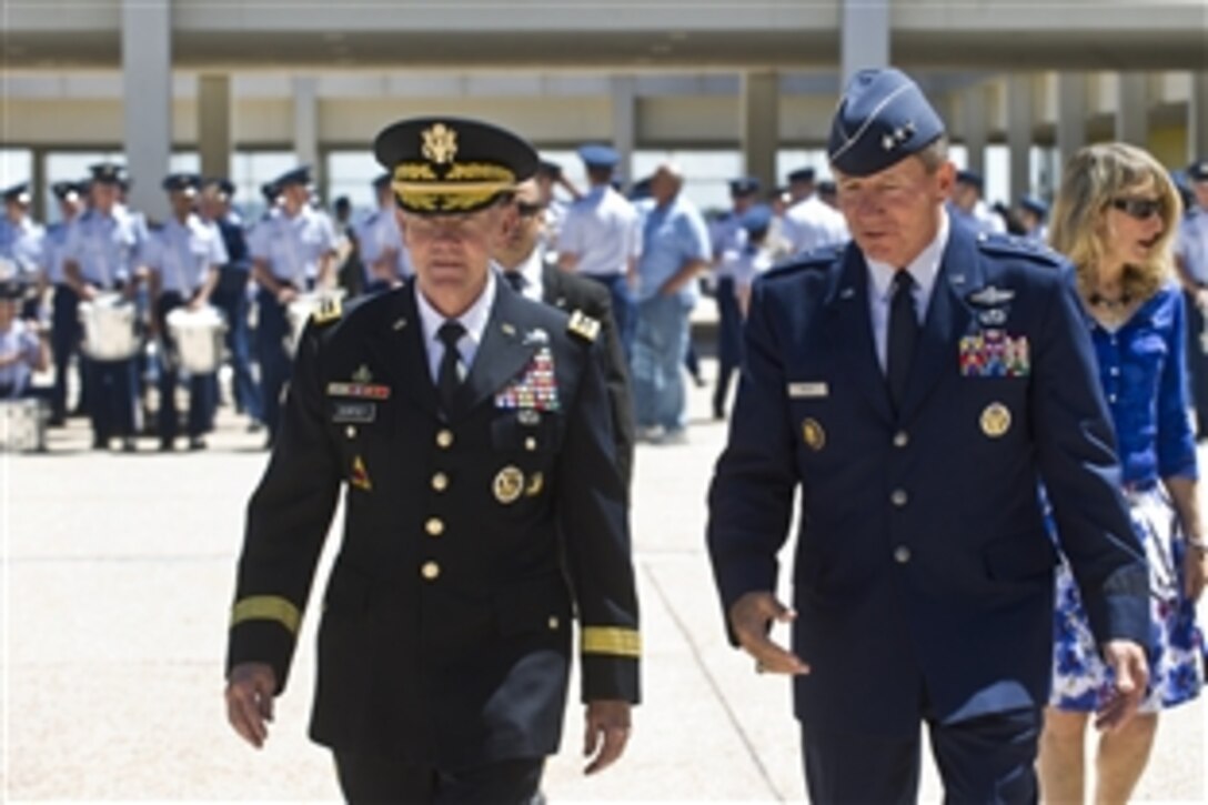 Army Gen. Martin E. Dempsey, chairman of the Joint Chiefs of Staff, walks with Air Force Lt. Gen. Michael C. Gould, superintendent of the Air Force Academy in Colorado Springs, Colo., April 30, 2012.