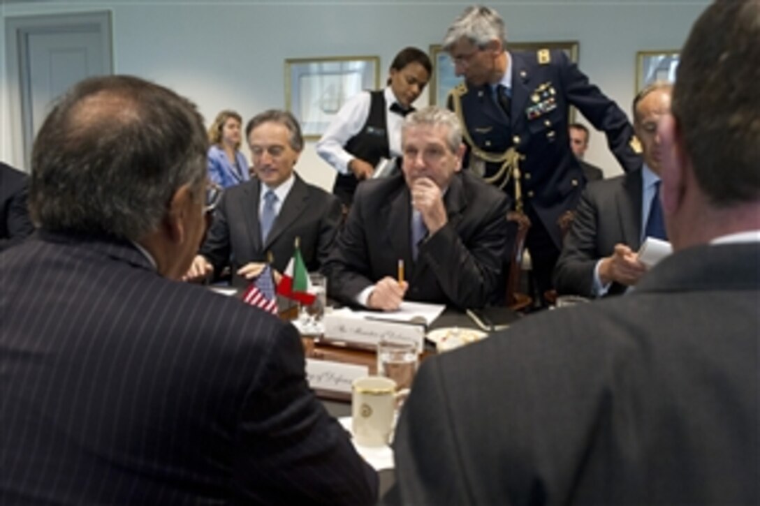 Italian Minister of Defense Giampaolo Di Paola (center) listens to Secretary of Defense Leon E. Panetta during a meeting in the Pentagon on April 30, 2012. 