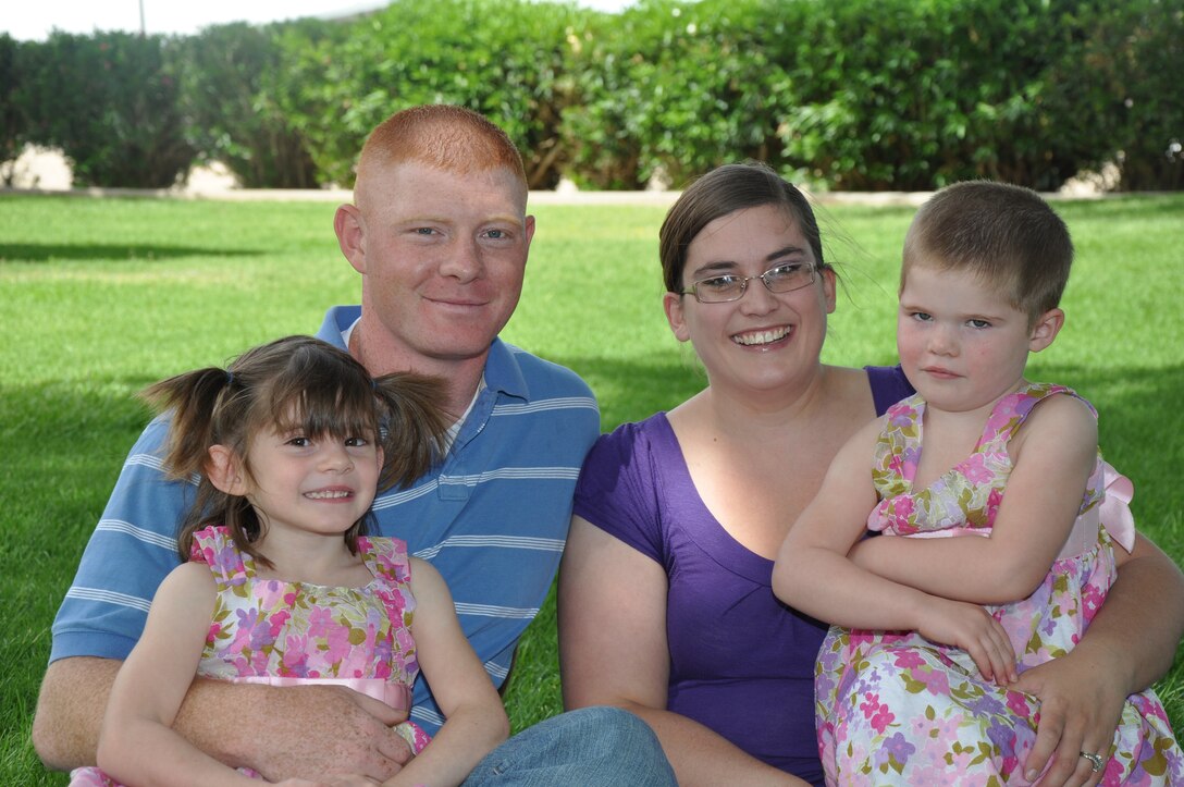 Sgt. Jacey Marks and wife Nichole sit with their two children, May 1. The family has been through rough times, but Jacey explains that no matter where he is, he can always trust that everything will be fine back home because of his wife.
