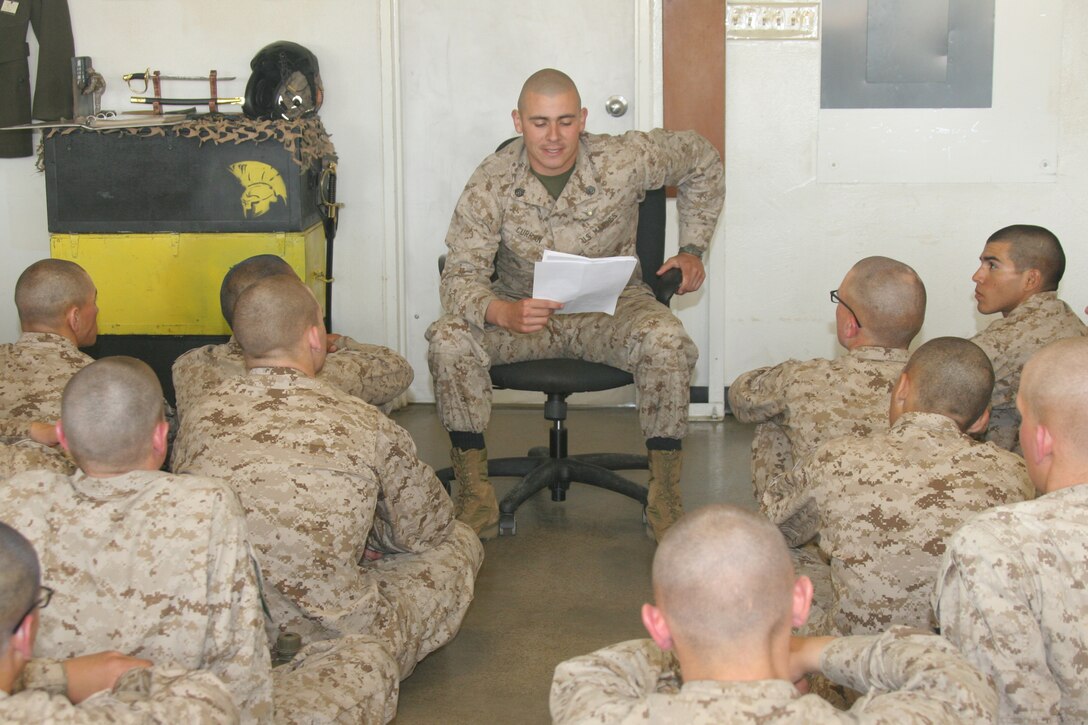 Staff Sgt. Zachary Curran, senior drill instructor, Platoon 2110, Company E, 2nd Recruit Training Battalion, leads his recruits in a guided discussion May 1 aboard Marine Corps Recruit Depot San Diego. The role of the senior drill instructor throughout recruit training is to develop recruits into disciplined, physically-fit Marines, but also mold them into Marines with strong moral values.