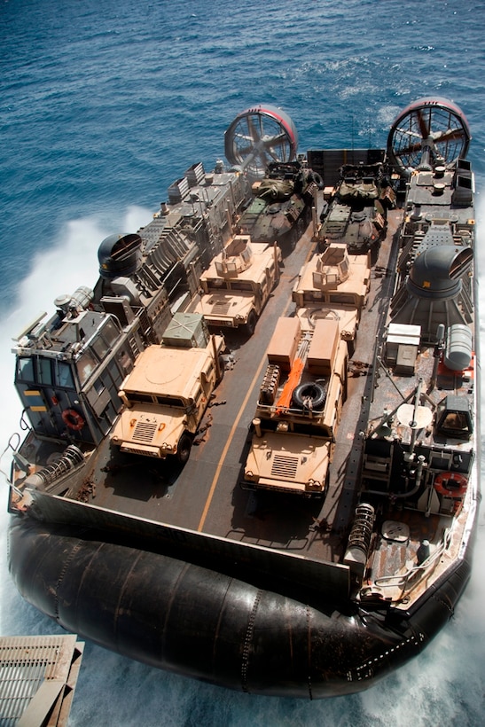 A Navy hovercraft with Assault Craft Unit 5 departs USS Makin Island carrying 11th Marine Expeditionary Unit vehicles and personnel here May 1. The units are deployed as part of the Makin Island Amphibious Ready Group, currently a U.S. Central Command theater reserve force. The group is providing support for maritime security operations and theater security cooperation efforts in the U.S. Navy's 5th Fleet area of responsibility.