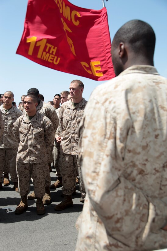 Marines and sailors with the 11th Marine Expeditionary Unit gather after a ceremony aboard USS Makin Island here May 1. The unit is deployed as part of the Makin Island Amphibious Ready Group, currently a U.S. Central Command theater reserve force. The group is providing support for maritime security operations and theater security cooperation efforts in the U.S. Navy's 5th Fleet area of responsibility.