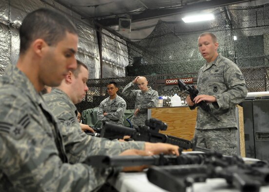 Staff Sgt. Jeffrey Sindelar, 627th Security Forces Squadron, demonstrates the proper disassembly and reassembly of an M-16 during the weapons familiarization portion of “Ability to Survive and Operate” training May 1, 2012, at Joint Base Lewis-McChord, Wash. Airmen spent the first half of the day rotating between eight different stations of ATSO University. Each station included a briefing by a subject matter expert from the respective career field. (U.S. Air Force photo/Senior Airman Leah Young)
