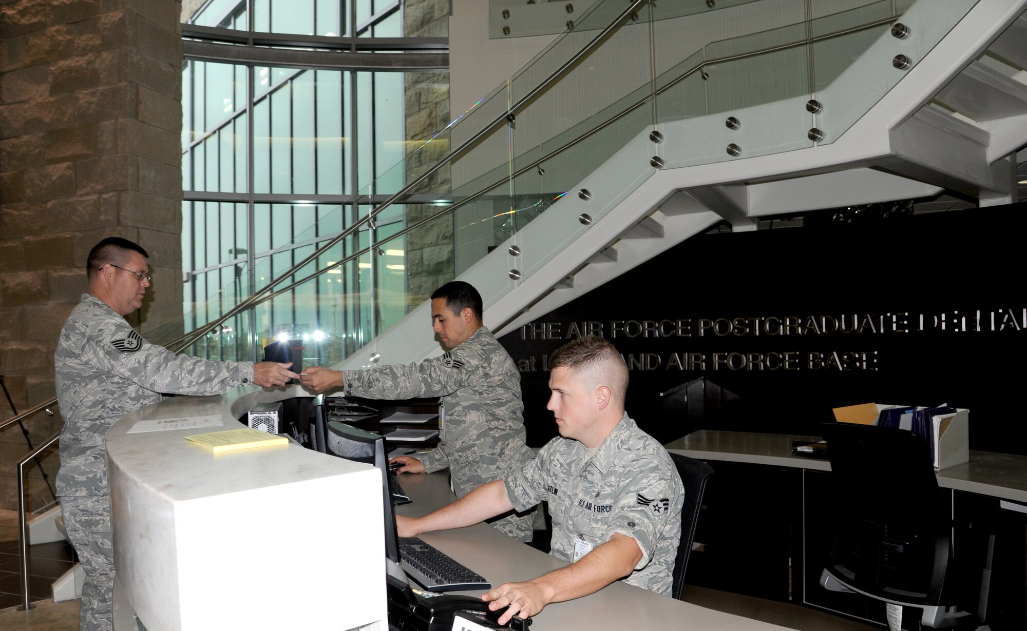 Senior Airmen Ryan Catlin (front) and Ivan Avarro schedules appointments and sign in patients at the recently opened Air Force Post Graduate Dental School and Clinic on Lackland Air Force Base, Texas, May 2, 2012.  Catlin and Navarro are dental technicians assigned to the 59th Dental Squadron. (U.S. Air Force Photo/Staff Sgt. Micky M. Bazaldua)