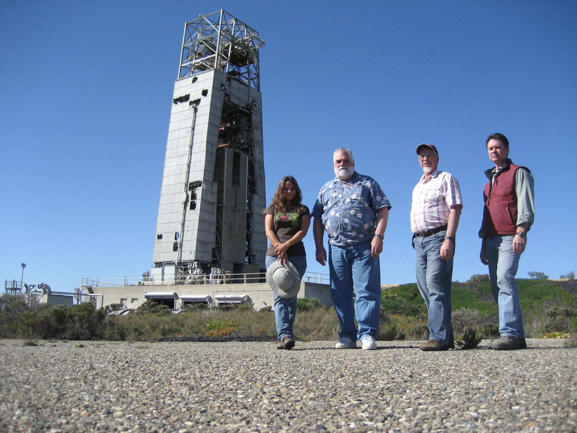 VANDENBERG AIR FORCE BASE, Calif. – Archeologists from 30th Civil Engineer Squadron Cultural Resources Management team, Kelli Brasket, Dr. James Carucci, Bob Peterson and Christopher Ryan, pose in front of the Advanced Ballistic Missile Re-Entry Systems site here. The gantry is the last one left in the world, and was also where the first nuclear-armed Inter-Continental Ballistic Missile went on alert in North America. (Courtesy photo)