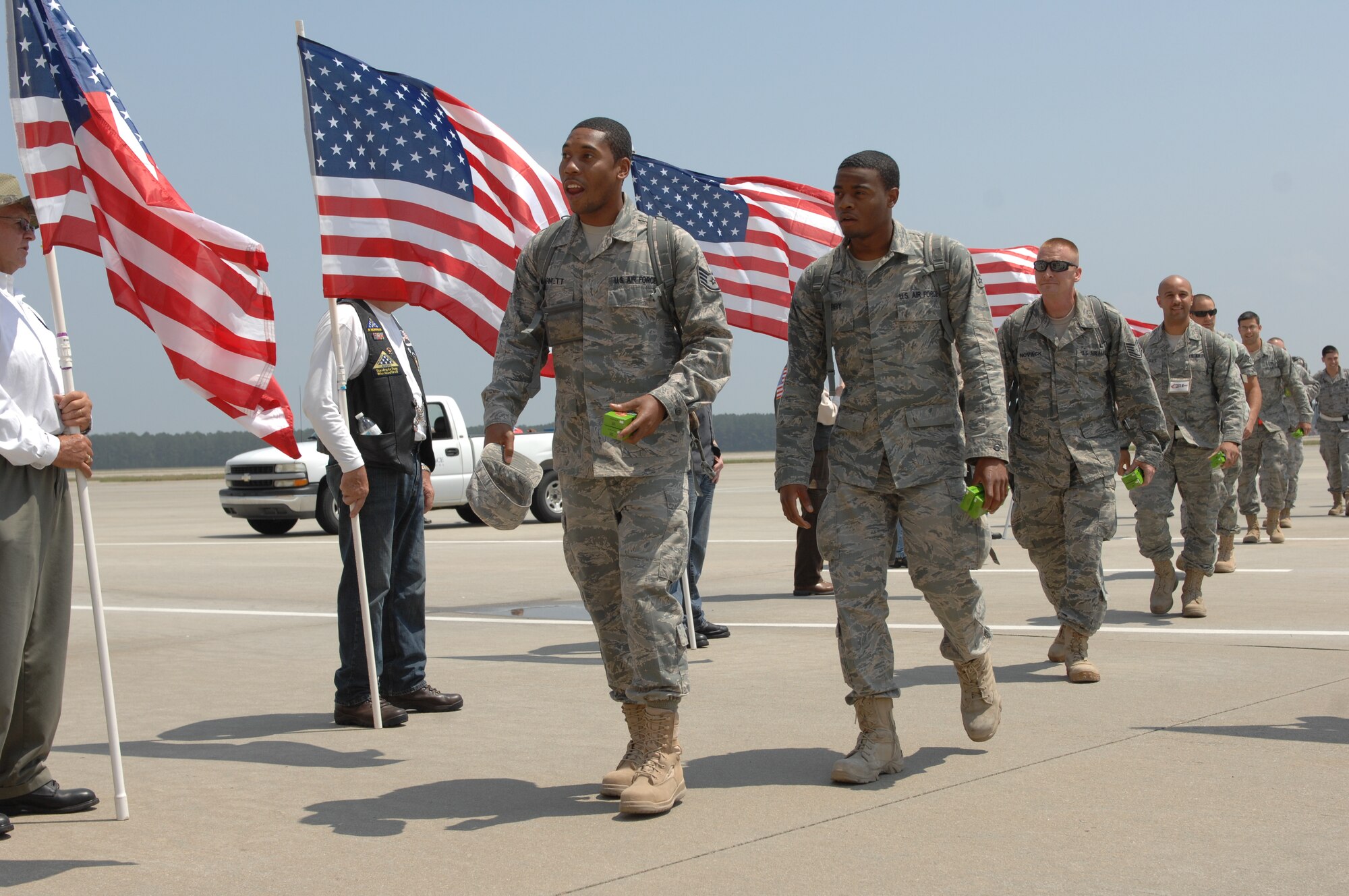 The 79th Fighter Squadron and the Tiger Aircraft Maintenance Unit are welcomed home by the Patriot Guard, along with friends and family on April 28 at Shaw Air Force Base, S.C. after a seven-month deployment to Iraq. The Patriot Guard honored the deployment veterans with a tunnel of flags upon their return. The 79th FS provided air support for the last two convoys to depart Iraq. (U.S. Air Force photo by Airman1st Class Krystal M. Jeffers/released)