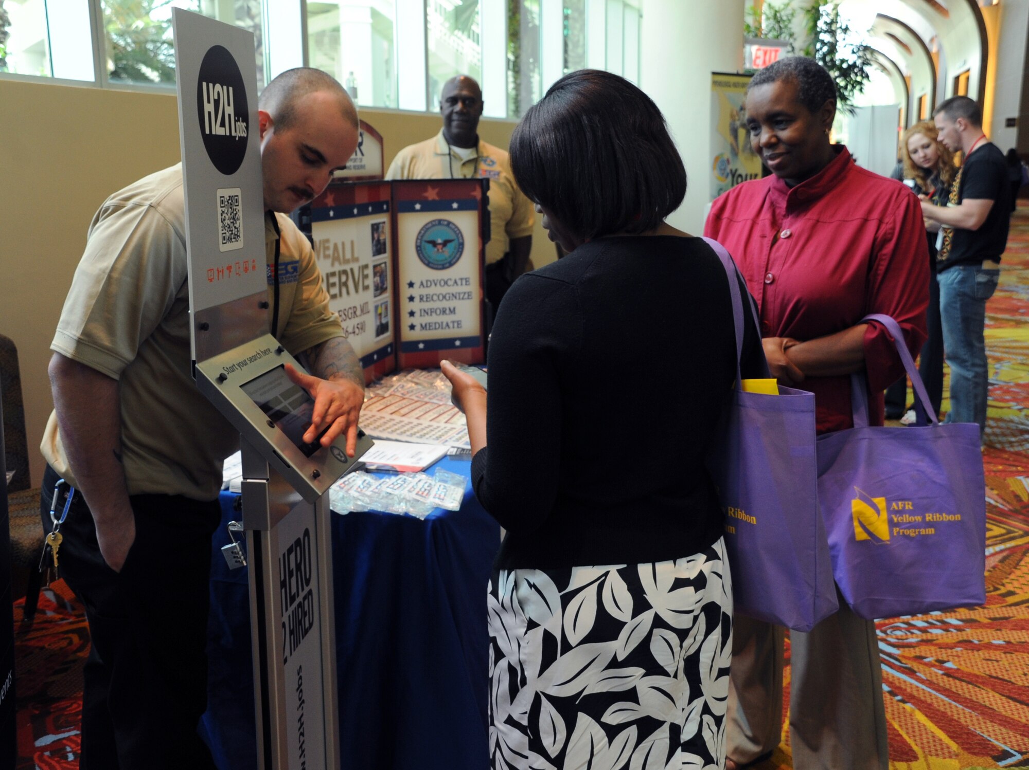 Hero 2 Hired, a job search organization for military members, shows their display to attendees at Air Force Reserve Command’s Yellow Ribbon Program in Orlando, Fla., April 29. Hero 2 Hired was one of many community partners and organizations who frequently support Yellow Ribbon events for pre-and post-deployment Reservists and their families. (U.S. Air Force photo/Staff Sgt. Anna-Marie Wyant)