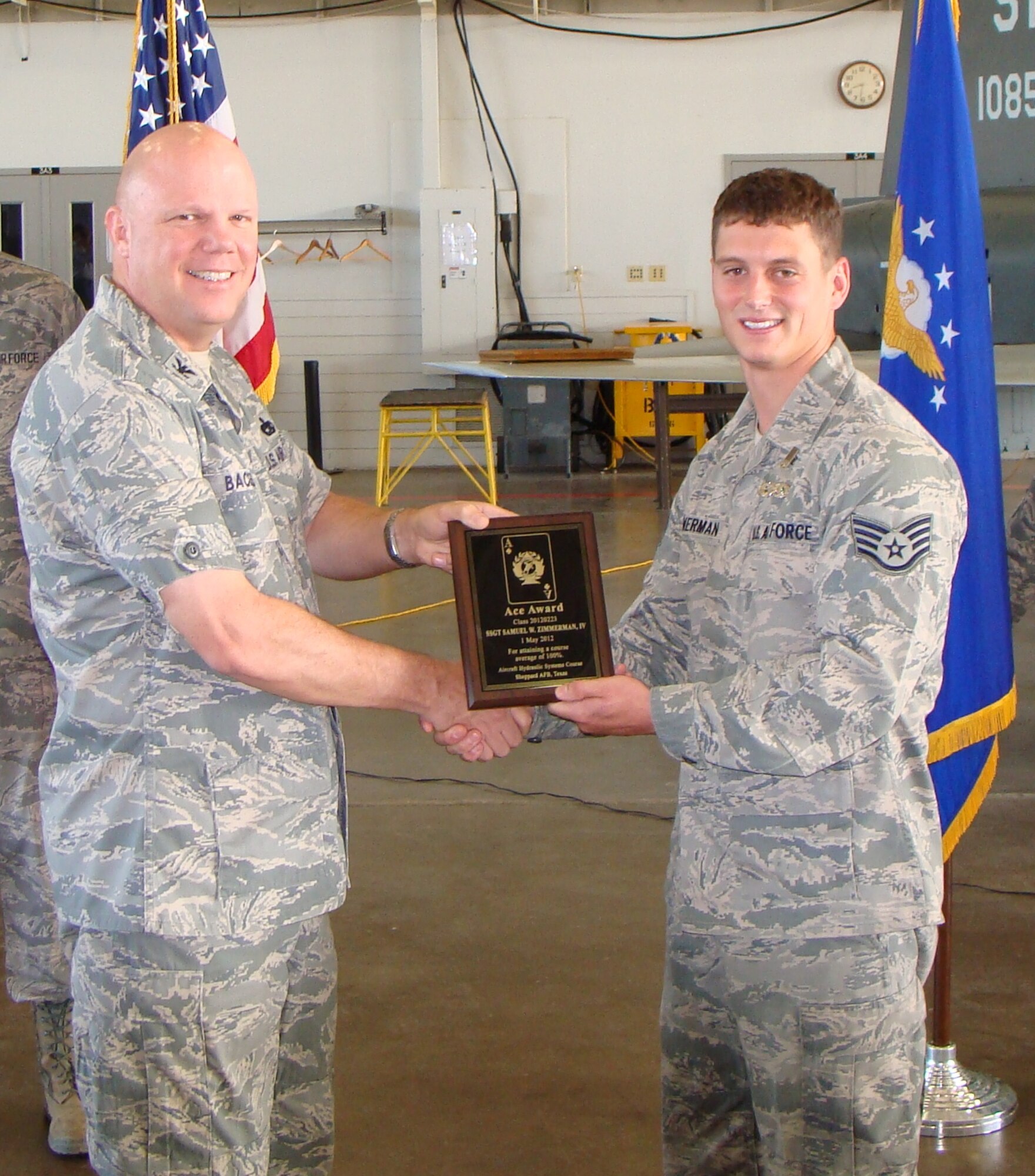Col. Kenneth Backes (left), 782nd Training Group commander, congratulates Staff  Sgt. Samuel Zimmerman IV on receiving his ACE Award after graduating from the 364th Training Squadron's Hydraulics Systems Apprentice Course with a 100 percent average May 2, 2012 at Sheppard Air Force Base, Texas.  The ACE award is given for academic excellence in a course when the student completes all required work with a 100 percent score. (U.S. Air Force courtesy photo)