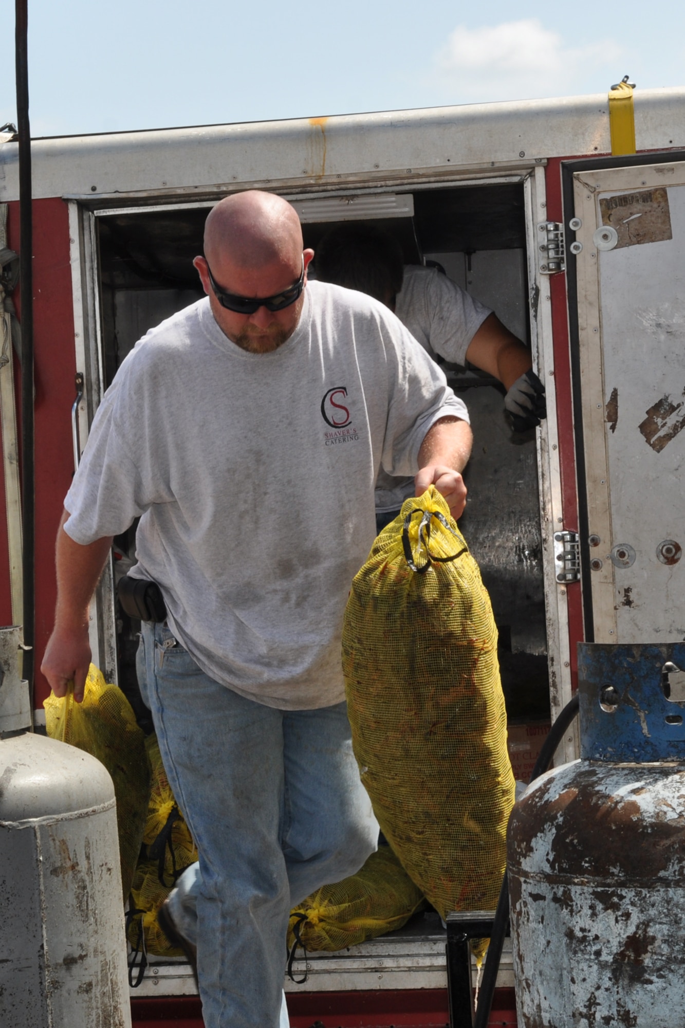 Jeremy Gray, with Shaver’s Catering in Shreveport, La., unload bags of live crawfish to prepare for a luncheon in the A-10 Hangar at Barksdale Air Force Base, La., April 30, 2012. The luncheon, which was held for Airmen from the 307th Bomb Wing and 917th Fighter Group, was sponsored by Mr. Boyd Parker and Shreveport Rubber and Gasket Company in “appreciation for what Barksdale Air Force Base does for the freedom we enjoy.” (U.S. Air Force photo by Betty Stephens) 