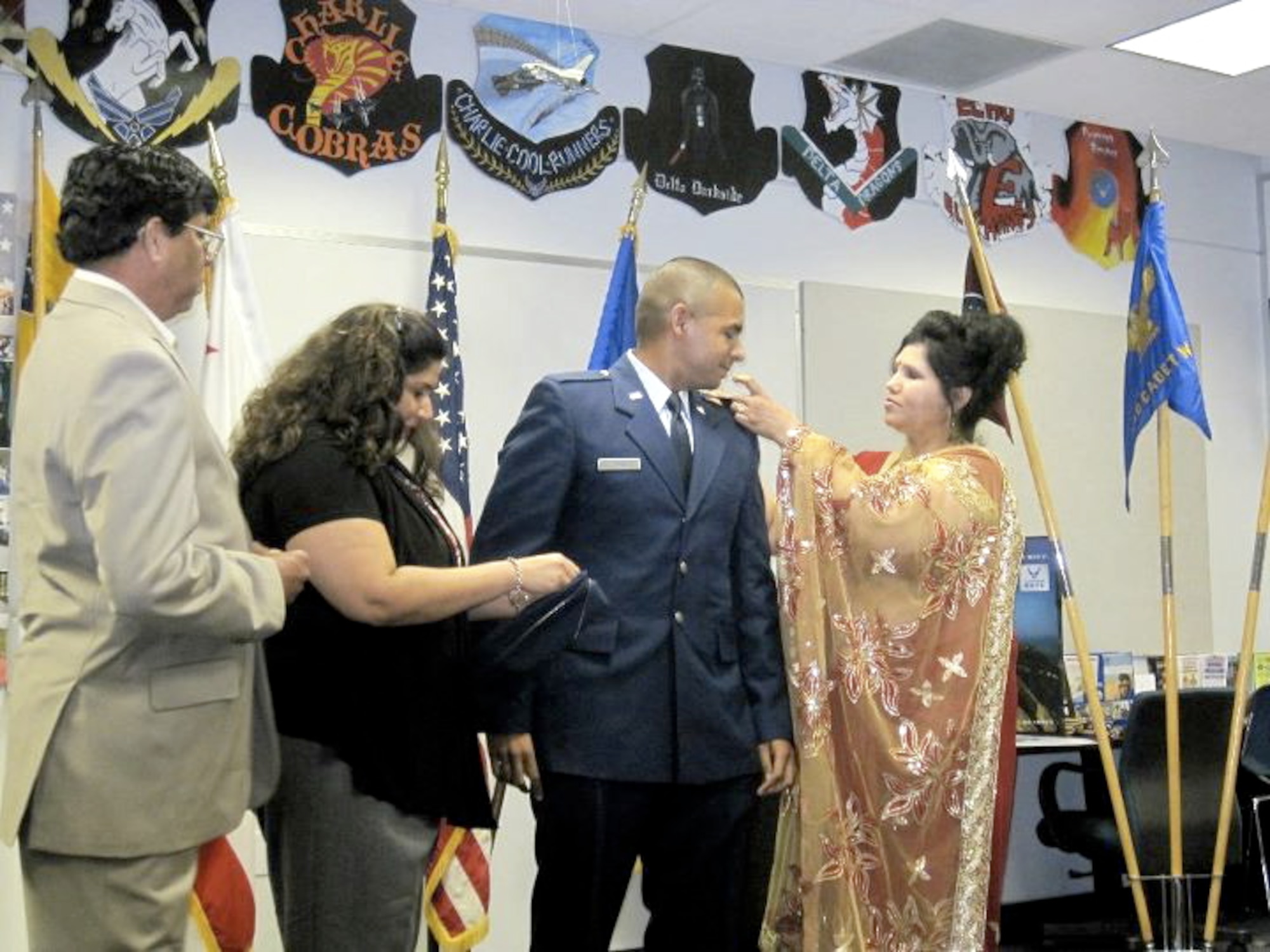 Members of 2nd Lt. Jason Ram's family pin on his second lieutenant bars at his commissioning at Loyola Marymount University, August 26, 2011.  Lieutenant Ram is currently stationed with the 479th Flying Training Group at Naval Air Station Pensacola, Fla.  The 479th FTG is the 12th Flying Training Wing's geographically separated unit and conducts Combat Systems Officer Training for the U.S. Air Force.  (Courtesy Photo)