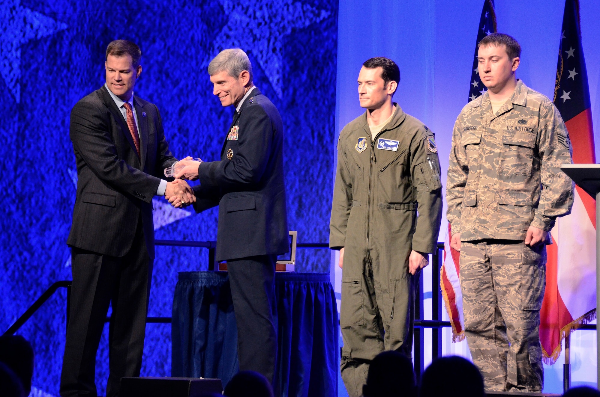 Jeff Babione, F-16 and F-22 Programs vice president and general manager, turns over the symbolic key to the last production F-22 Raptor to Air Force Chief of Staff, Gen. Norman A. Schwartz, along with Lt. Col. Paul Moga, 525th Fighter Squadron commander and his crew chief Staff Sgt. Damon Crawford at Lockheed Martin Aeronautics Company, Marietta, Ga., May 2. The last production aircraft, number 4195, was flown to Joint Base Elmendorf-Richardson, Alaska, by Lt. Col. Paul Moga. (U.S. Air Force photo/ Brad Fallin)