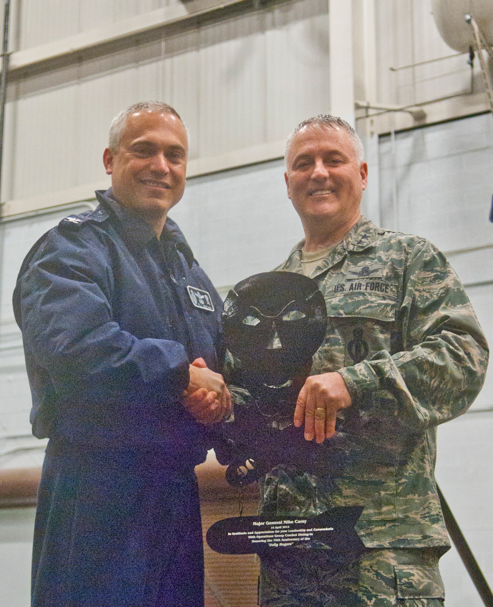 Col. Robert Vercher, 90th Operations Group commander, presents a 90th Operations Group Jolly Roger plaque to Maj. Gen. Michael Carey, Deputy Director for Command, Control and Nuclear Operations, J-3, Joint Staff, as a token of the 90th OG’s appreciation for his leadership and camaraderie in Building 1501 April 14. The plaque was presented at the combat dining-in, a morale-building event for the 90th OG. (U.S. Air Force photo by Airman Jason Wiese)