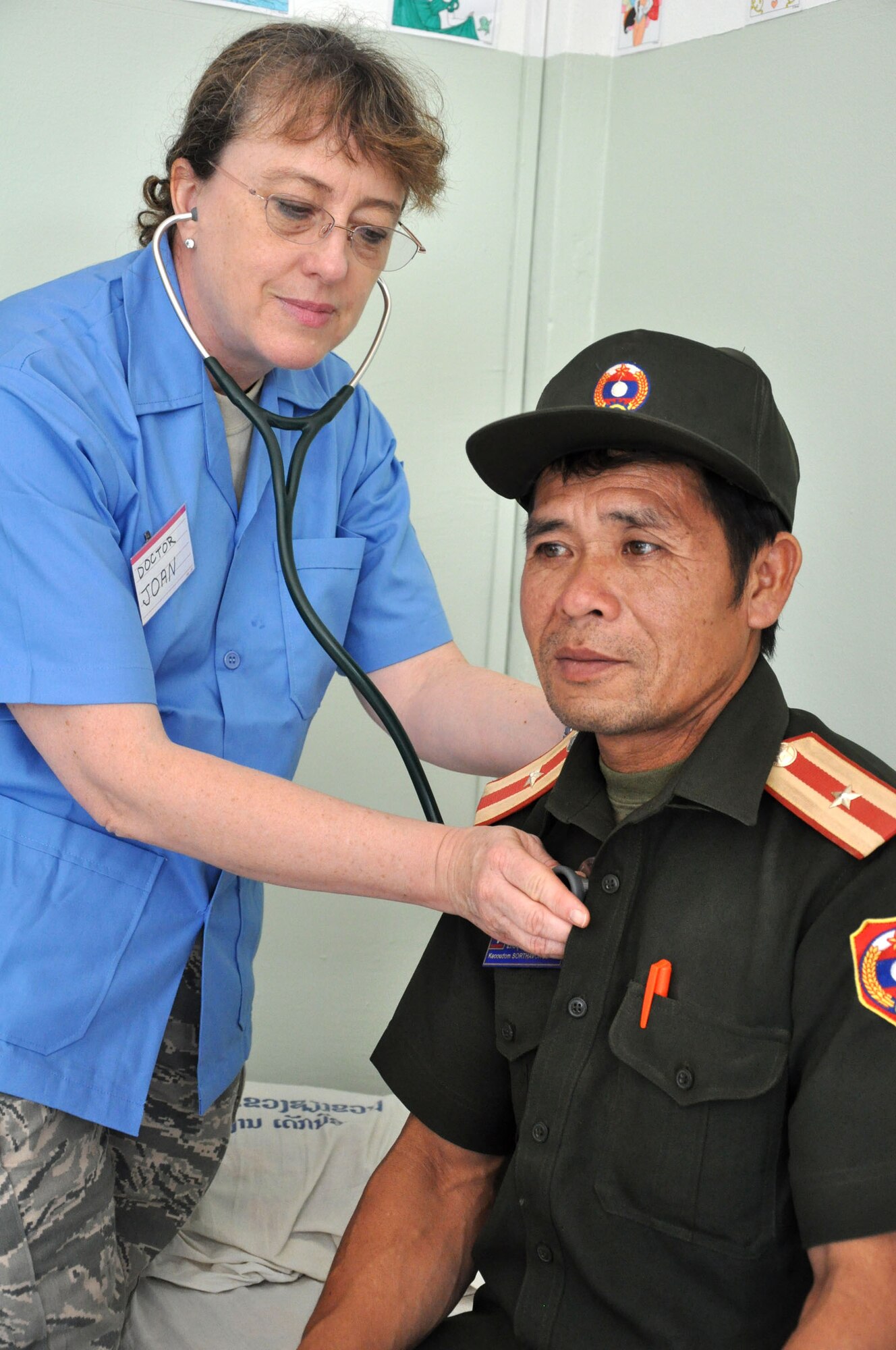 Dr. (Col.) Joann Basaran examines Lao People's Army Maj. Keoudom Sorthavongsack at the Lao-Mongolian Friendship Hospital in Phonsavahn, Laos, April 25. The major was one of more than 1,900 patients seen through April 26 as part of Operation PACIFIC ANGEL 12-2 - a joint and combined humanitarian assistance and capacity building mission. Thirty U.S. service members are partnering with Lao military and civilians to provide medical treatment, civil engineering projects, and educational exchanges from April 23-28. (U.S. Air Force photo/Master Sgt. Mike Hammond)