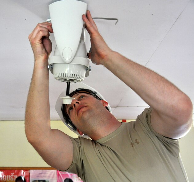 Tech. Sgt. Neil Hodawanus installs one of 15 ceiling fans Operation PACIFIC ANGEL engineers are providing at the Mother and Child Center of the Lao-Mongolian Friendship Hospital in Phonsavahn, Laos, April 25. Sergeant Hodawanus, a civil engineer utilities technician from the 773rd Civil Engineer Squadron at Joint Base Elmendorf-Richardson, Alaska, is one of 30 U.S. military members supporting Operation PACIFIC ANGEL 12-2 in Laos. PACANGEL is operating in three phases: civil engineering projects, medical care, and subject matter expertise exchanges between U.S. and Lao medics and engineers. (U.S. Air Force photo/Master Sgt. Mike Hammond)