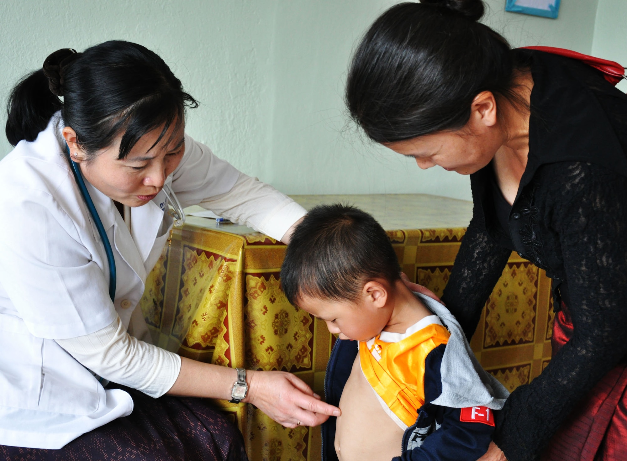 Dr. Khamla, a pediatrician at the Lao-Mongolian Friendship Hospital in Phonsavahn, Laos, examines a young boy seeking care as part of Operation PACIFIC ANGEL 12-2, April 24. As of April 26, U.S. Air Force, Navy, and Lao military and civilian providers have seen and treated more than 1,900 patients at no cost to the patient. In addition to medical care, medical and engineering subject matter expert exchanges and civil engineering renovations are taking place. PACANGEL 12-2 runs from April 23-28. (U.S. Air Force photo/Master Sgt. Mike Hammond)
 
