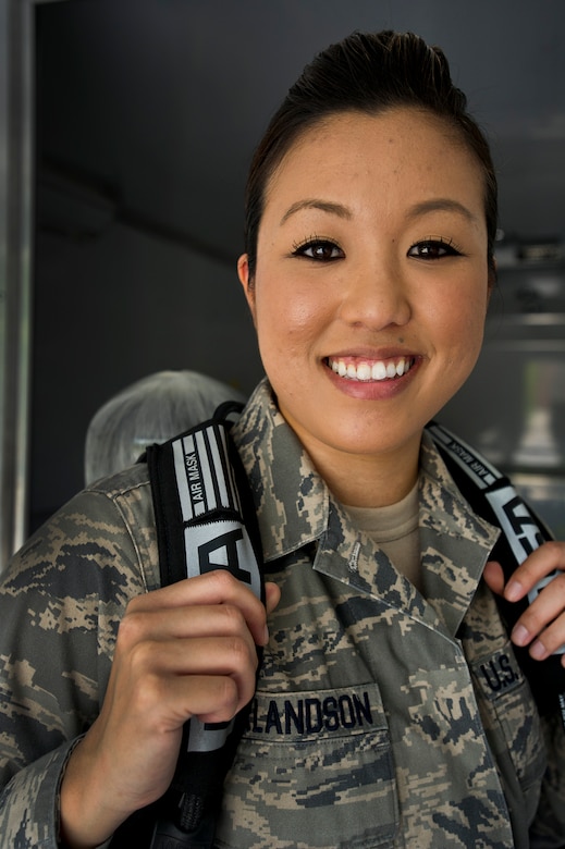 Senior Airman Leah Erlandson poses  with an MSA Firehawk self-contained breathing apparatus during a demonstration at Joint Base Charleston - Air Base  April 16. Bioenvironmental Engineering technicians perform health risk assessments for everyone on base to keep them safe from whatever exposures their job may present. Erlandson is a 628th Aerospace Medicine Squadron Bioenvironmental Engineering technician. (U.S. Air Force photo/Airman 1st Class George Goslin)