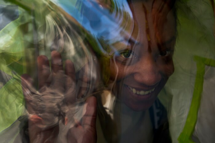 Senior Airman Ebony Brown poses for a photo while inside a Level A Fully-encapsulated HAZMAT suit at Joint Base Charleston - Air Base April 16. Bioenvironmental Engineering technicians perform health risk assessments for everyone on base to keep them safe from whatever exposures their job may present. Airman Brown is a 315th Aerospace Medicine Squadron Bioenvironmental Engineering technician. (U.S. Air Force photo/Airman 1st Class George Goslin)