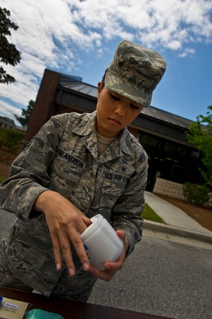 Senior Airman Leah Erlandson unpacks a sample jar from a Quiksilver chemical and biological testing kit during a demonstration at Joint Base Charleston - Air Base April 16. Bioenvironmental Engineering technicians perform health risk assessments for everyone on base to keep them safe from whatever exposures their job may present. Erlandson is a 628th Aerospace Medicine Squadron Bioenvironmental Engineering Technician. (U.S. Air Force photo/Airman 1st Class George Goslin)