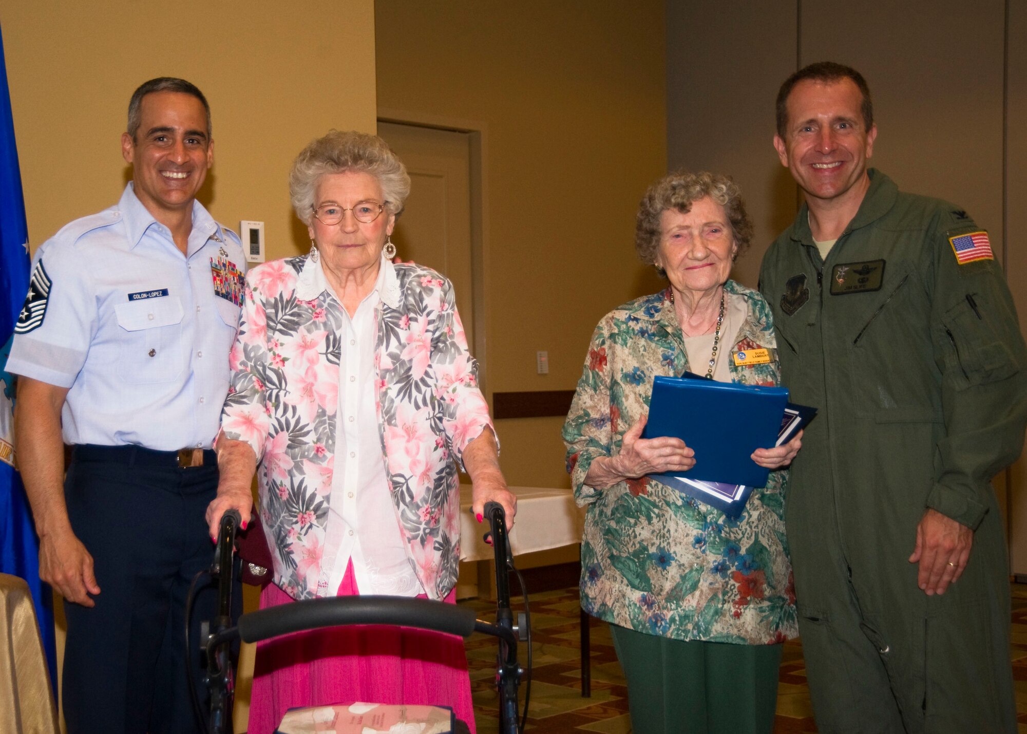 (From left to right) U.S. Air Force Chief Master Sgt. Ramon Colon-Lopez, command chief of 1st Special Operations Wing, Rae Eubert, Susie Lambert and Col. Jim Slife, commander of 1st SOW, pose for a photo at the Volunteer Recognition Ceremony at the Soundside Club at Hurlburt Field, Fla., May 1, 2012. Ruebert and Lambert both received the Volunteer Excellence Award for their work in 2011. in 2011.(U.S. Air Force photo by Airman 1st Class Naomi M. Griego/RELEASED) 
