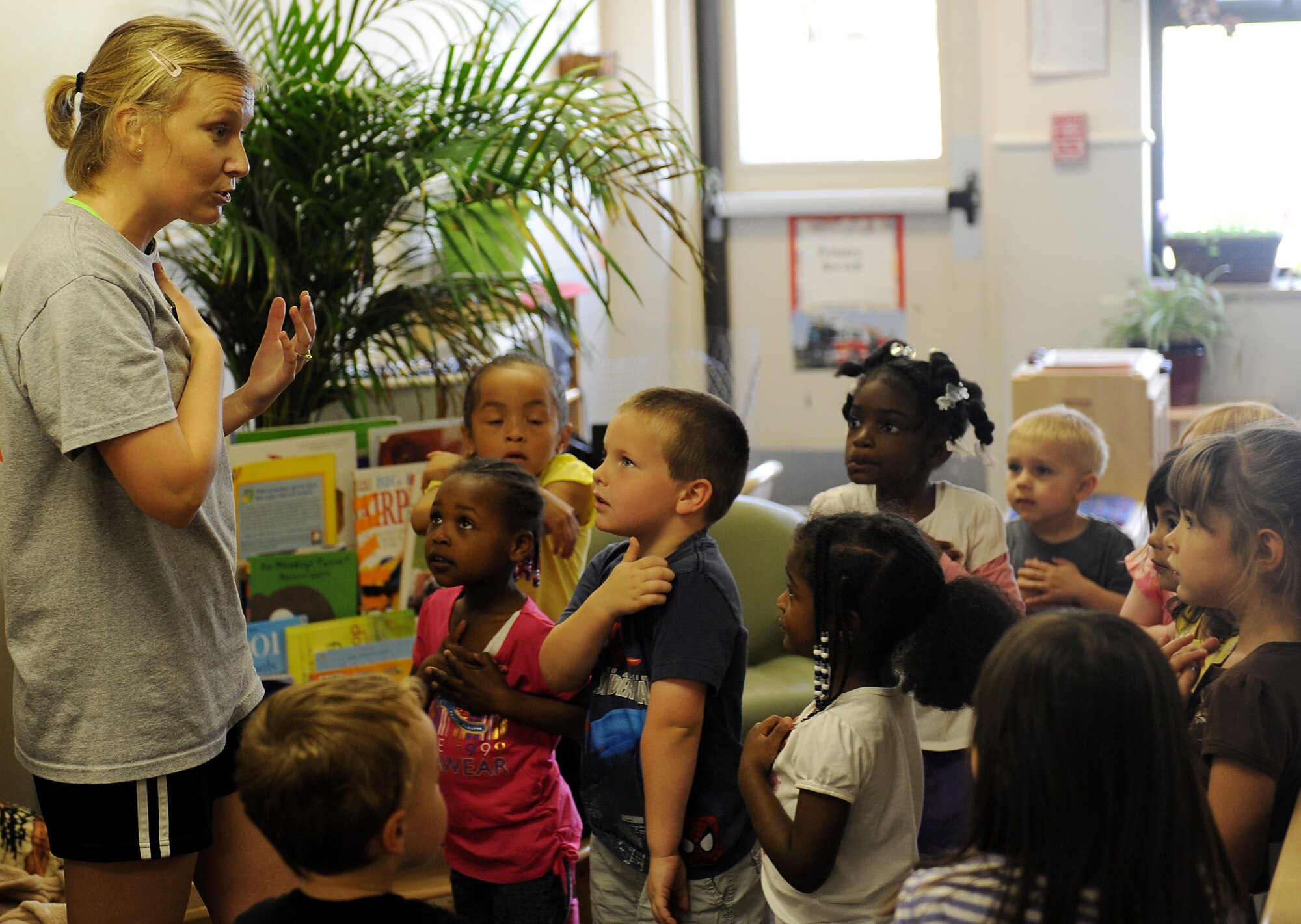 Laura Weighlein, Health and Wellness Center health technician, teach the children of the Child Development Center about fitness April 25, 2012 at Scott Air Force Base, Ill.  April is the Month of the Military Child and Physical Fitness Month. (U.S. Air Force photo/Airman 1st Class Divine Cox)